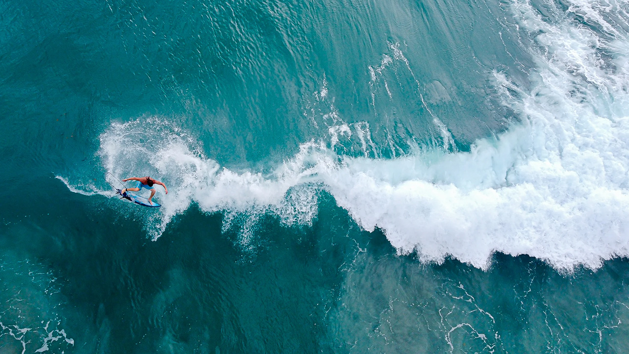 Surfer mid air through a 360 jump
