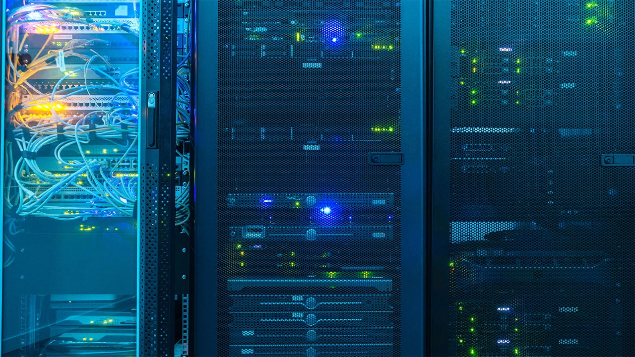 Close-up of servers in a server room with blue light