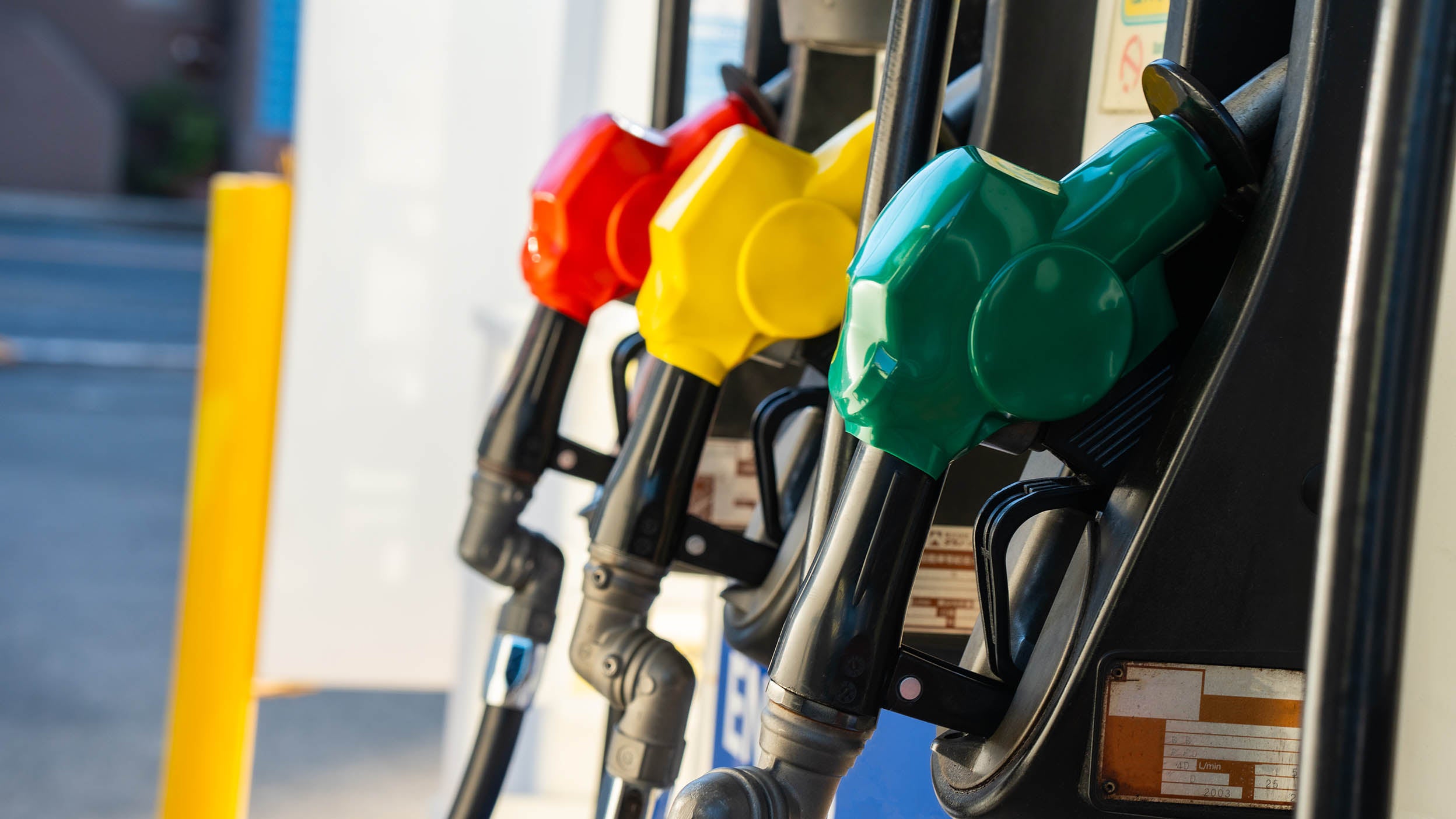 Close-up of a gas station's gasoline pumps and fuel nozzles 