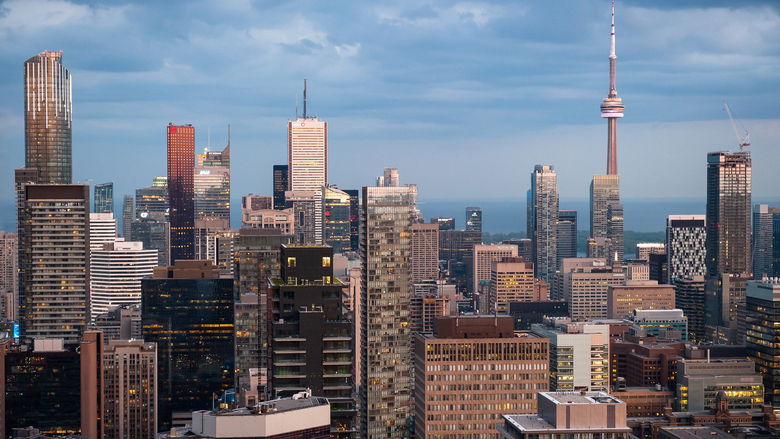 City skyline with tall modern buildings under a cloudy sky