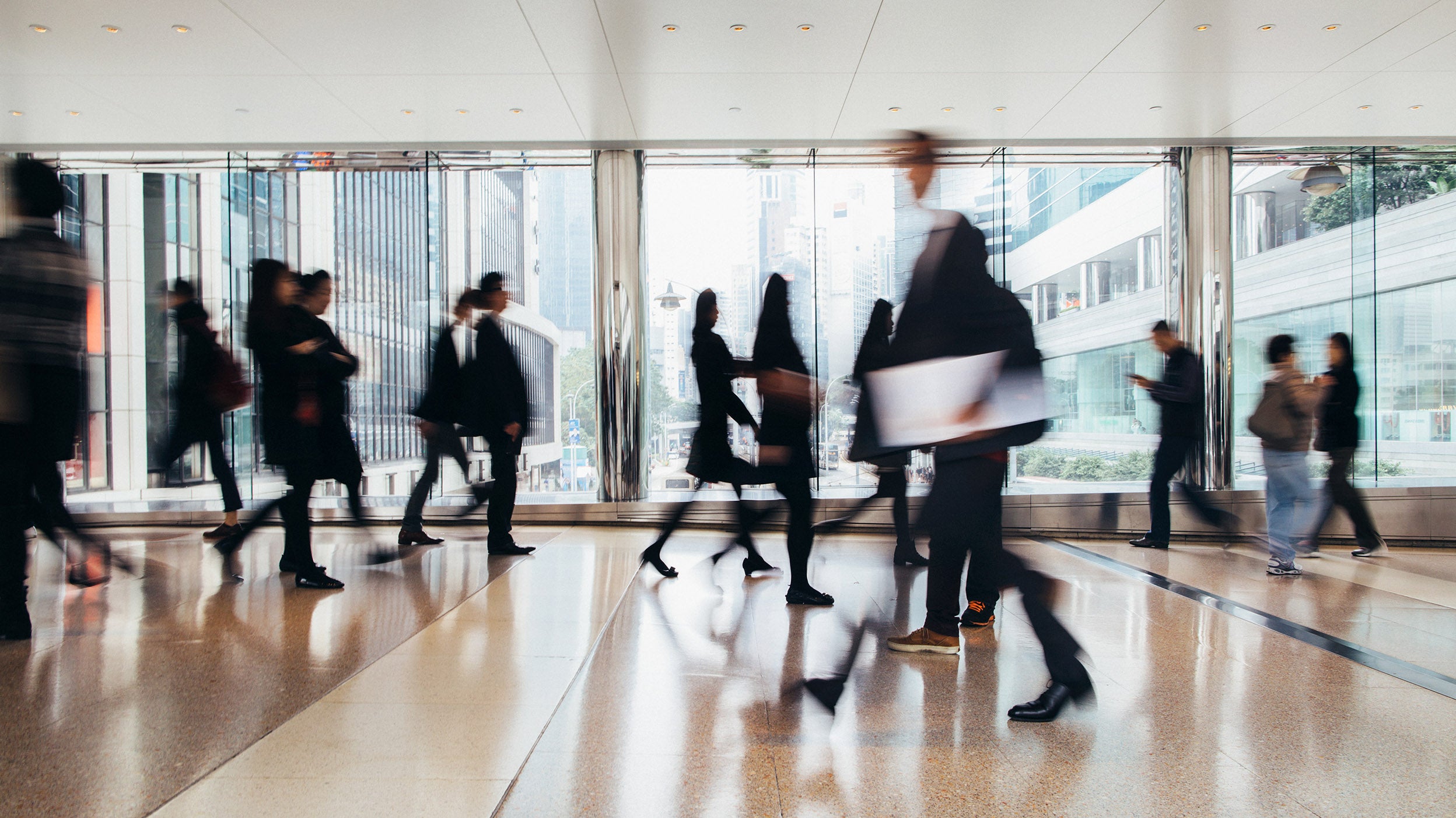 business people walking and talking, blurred motion