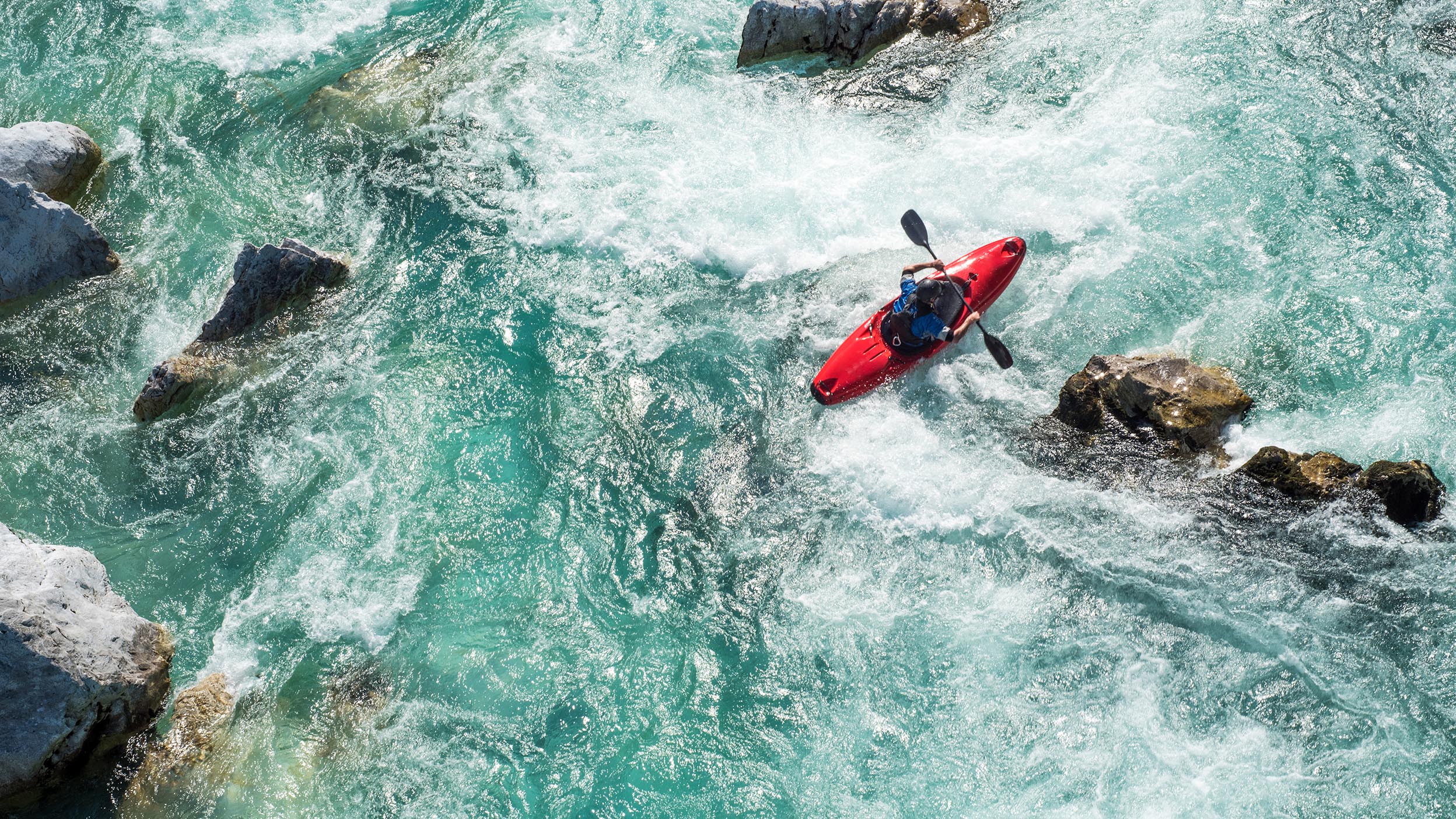 Kayaker navigating choppy waters.