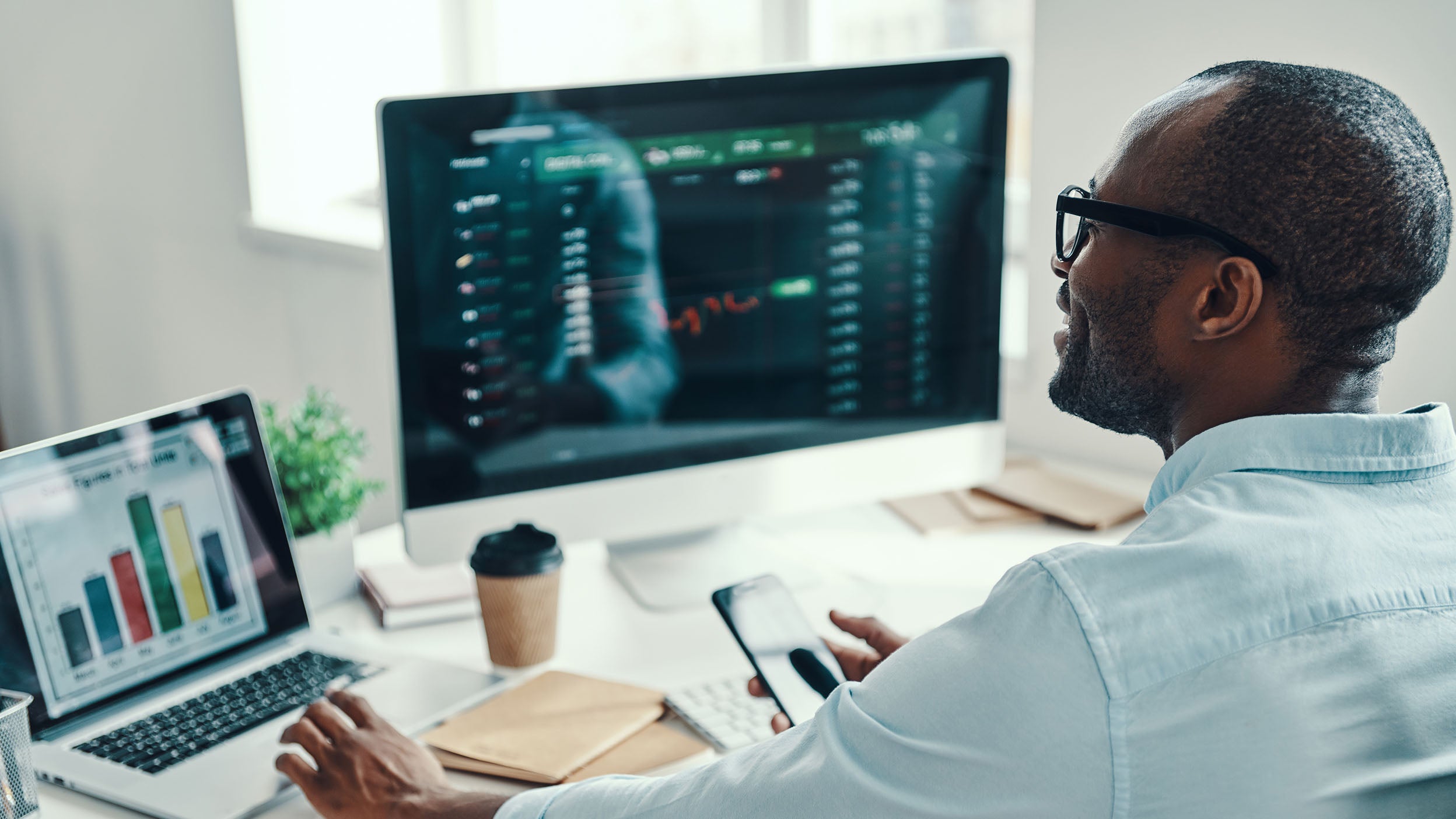 Man working on his laptop related to stocks