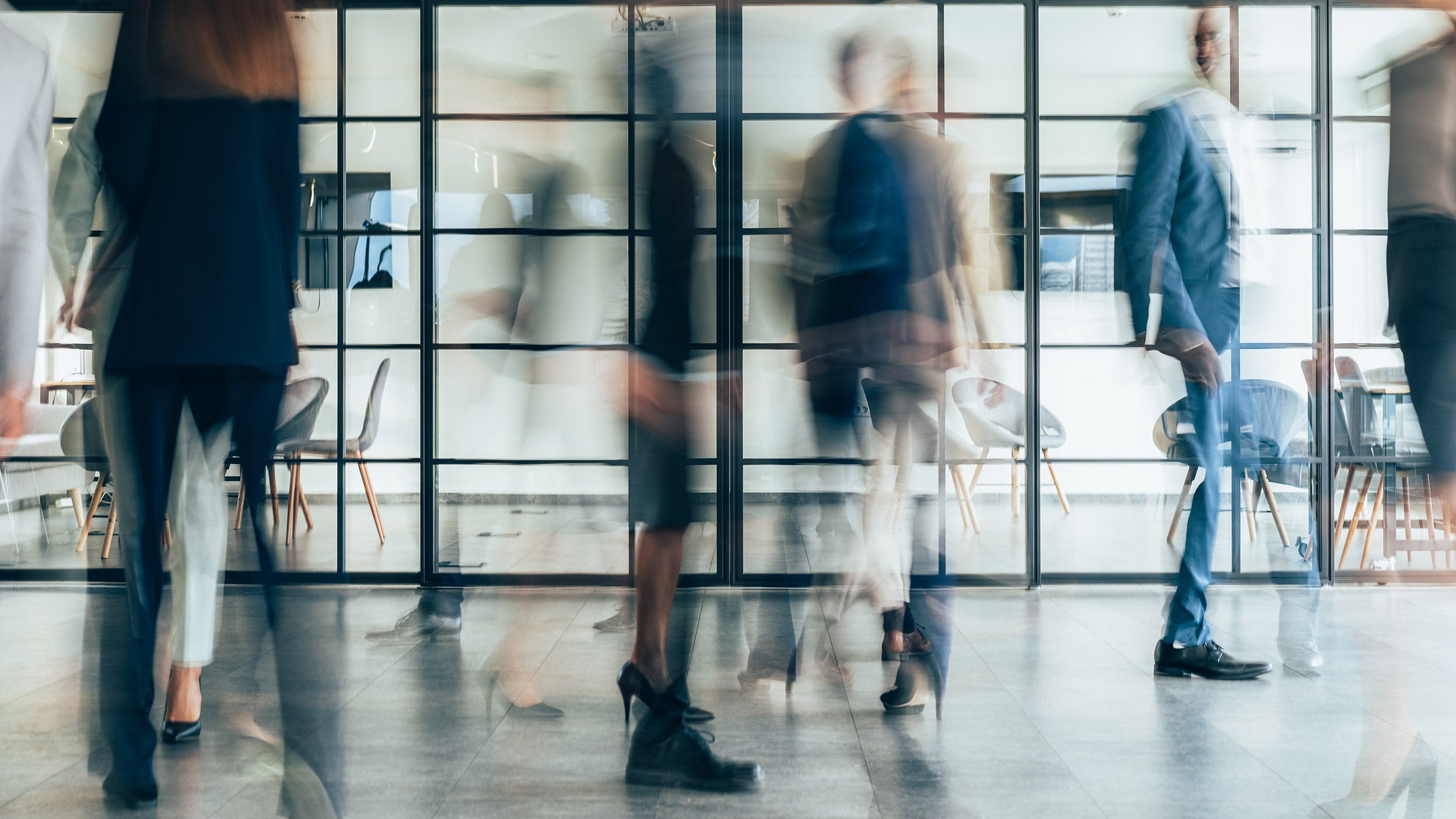 Busy modern workplace. Working process in the office, business people working, walking and talking, blurred motion