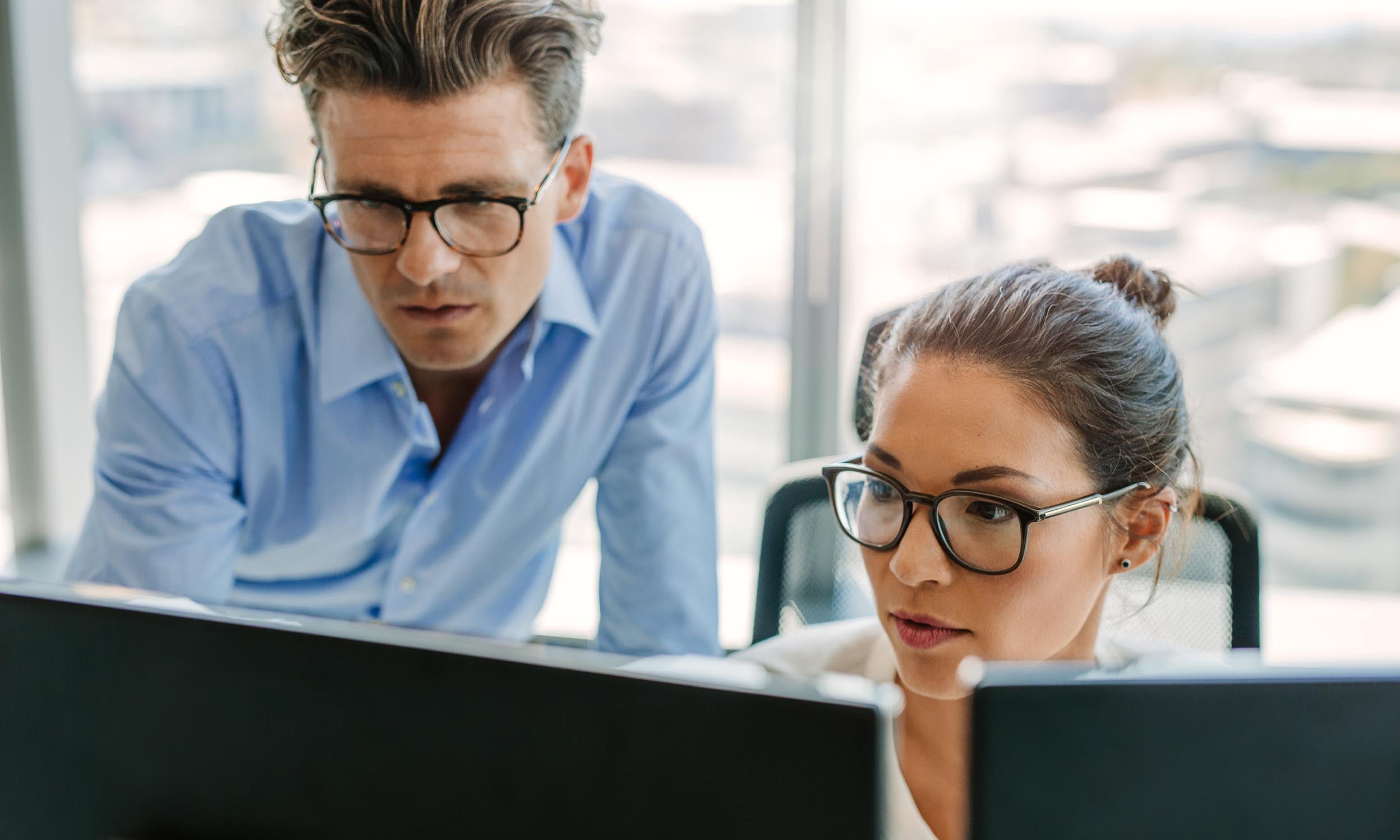 two people looking at a monitor
