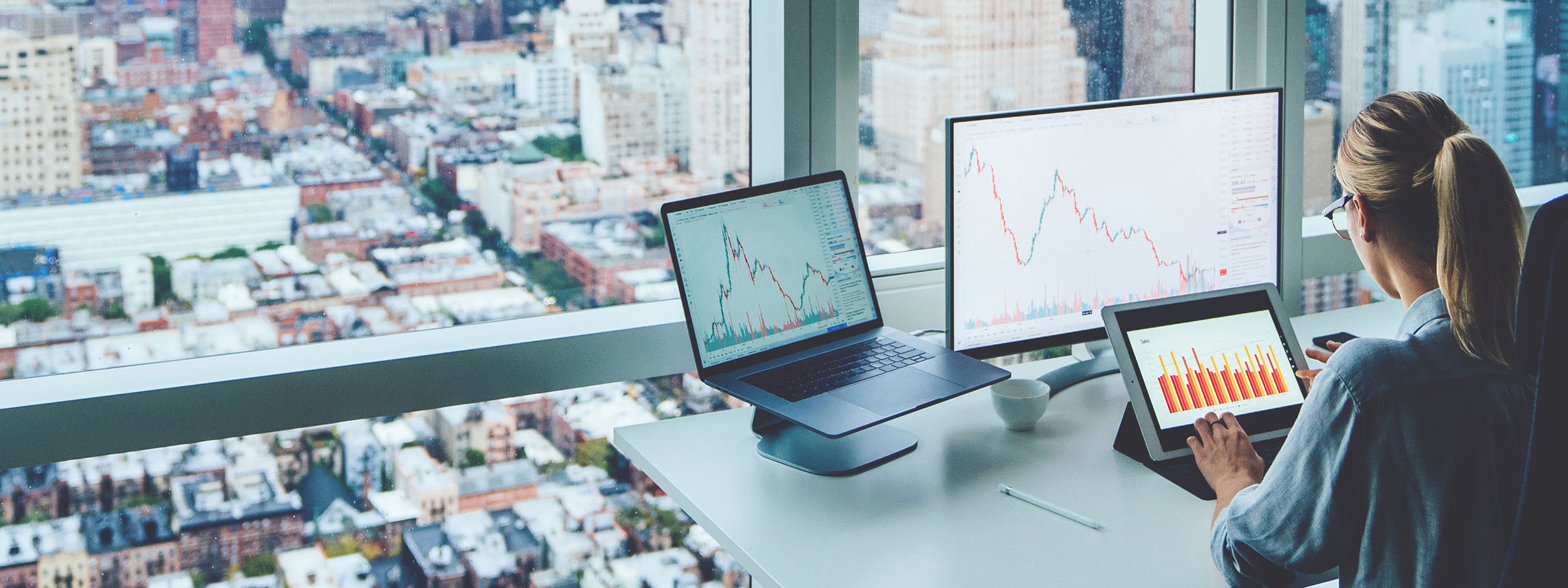 Woman working/monitoring the stock market 