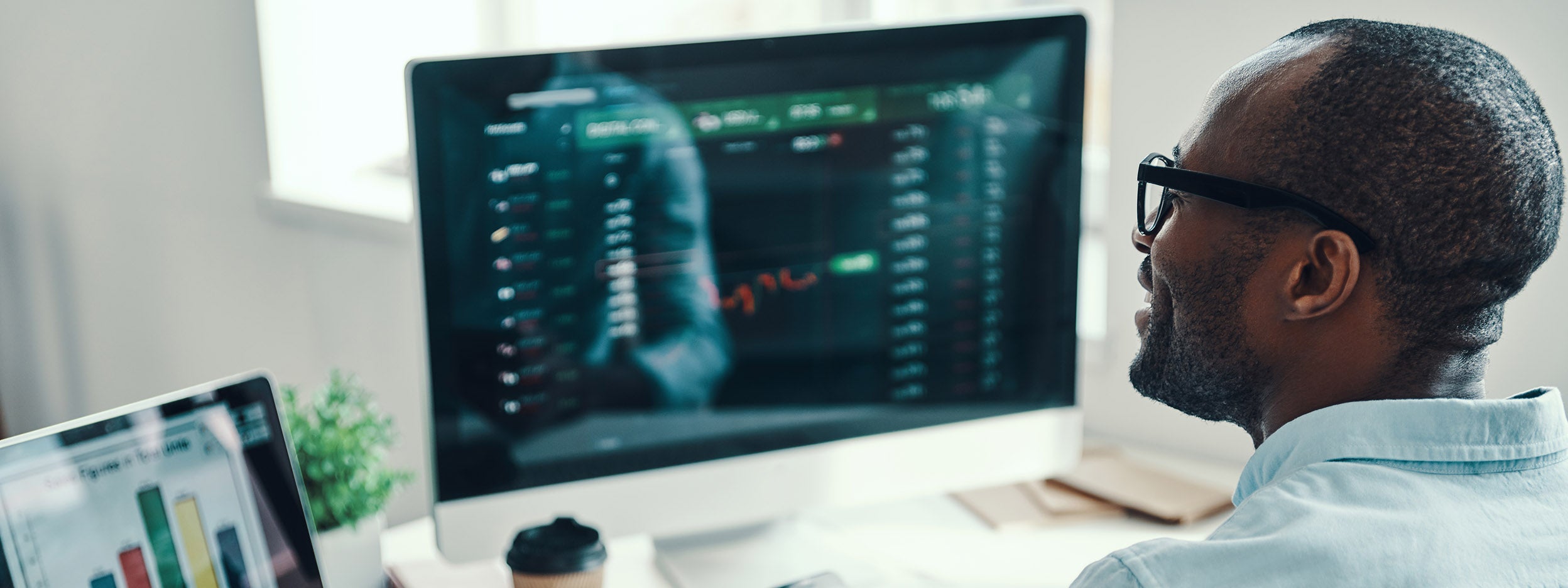 Man working on his laptop related to stocks