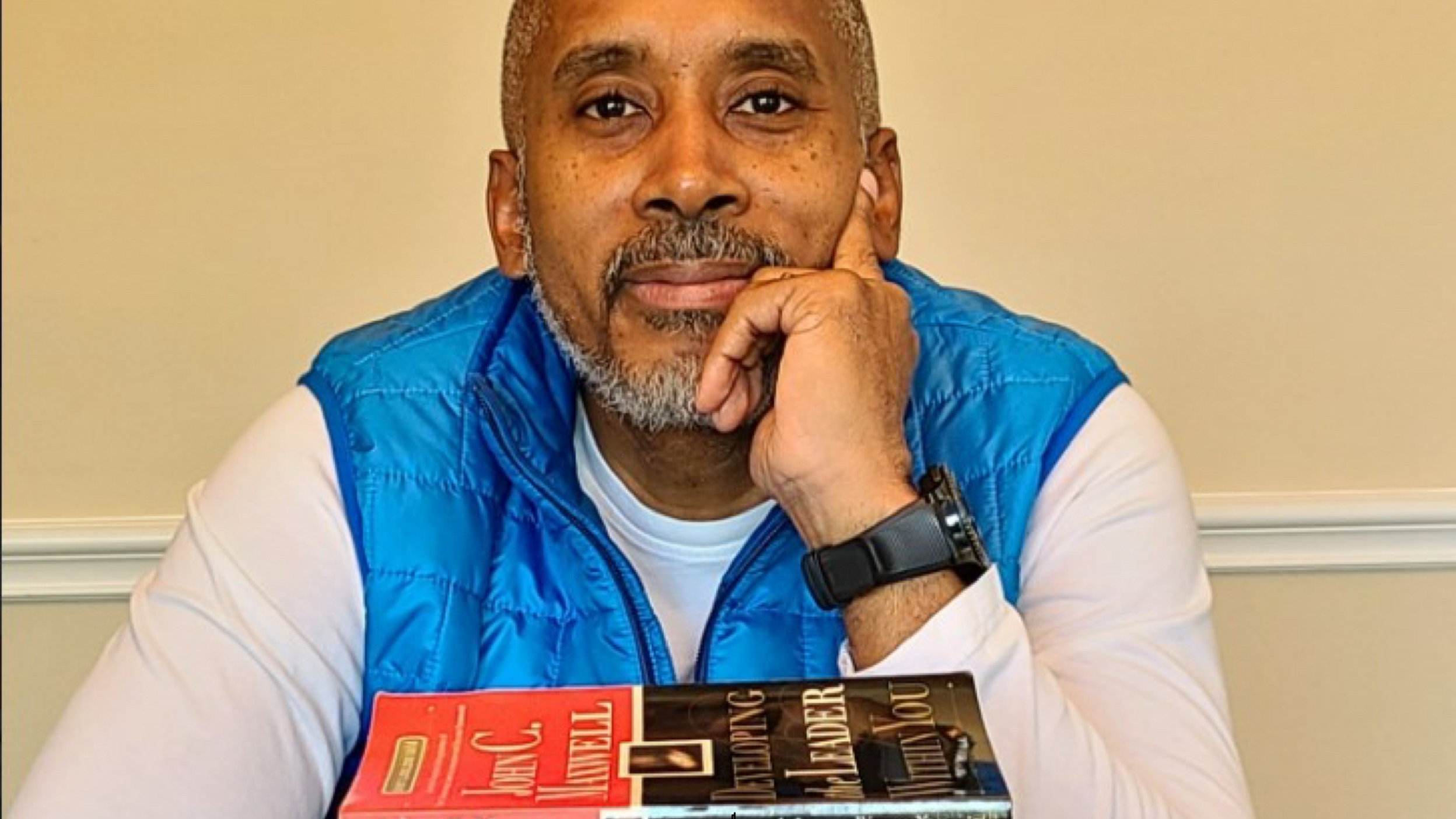  Invesco employee with stack of his recommended books 