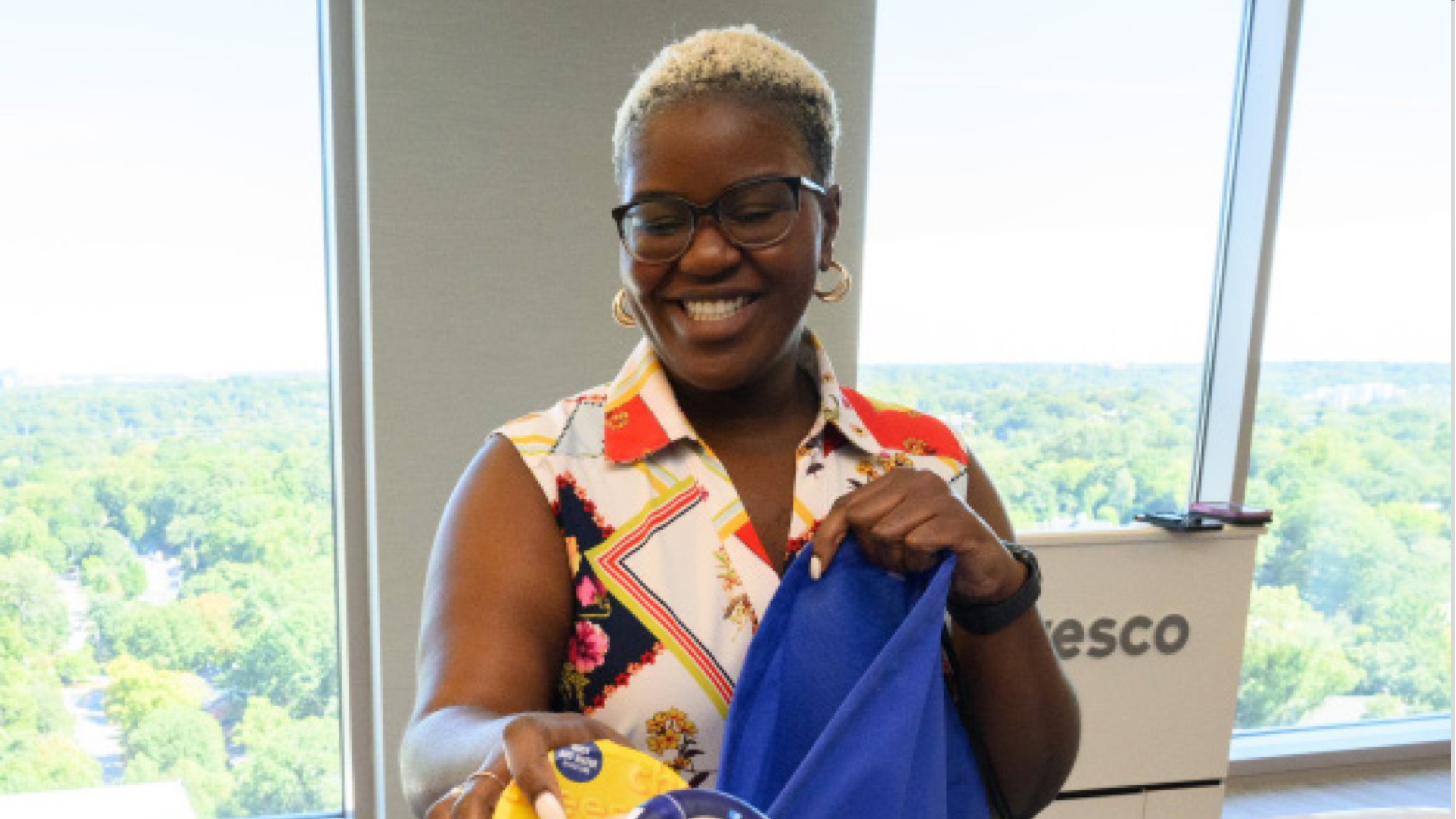 Smiling employee volunteering at Invesco Cares event