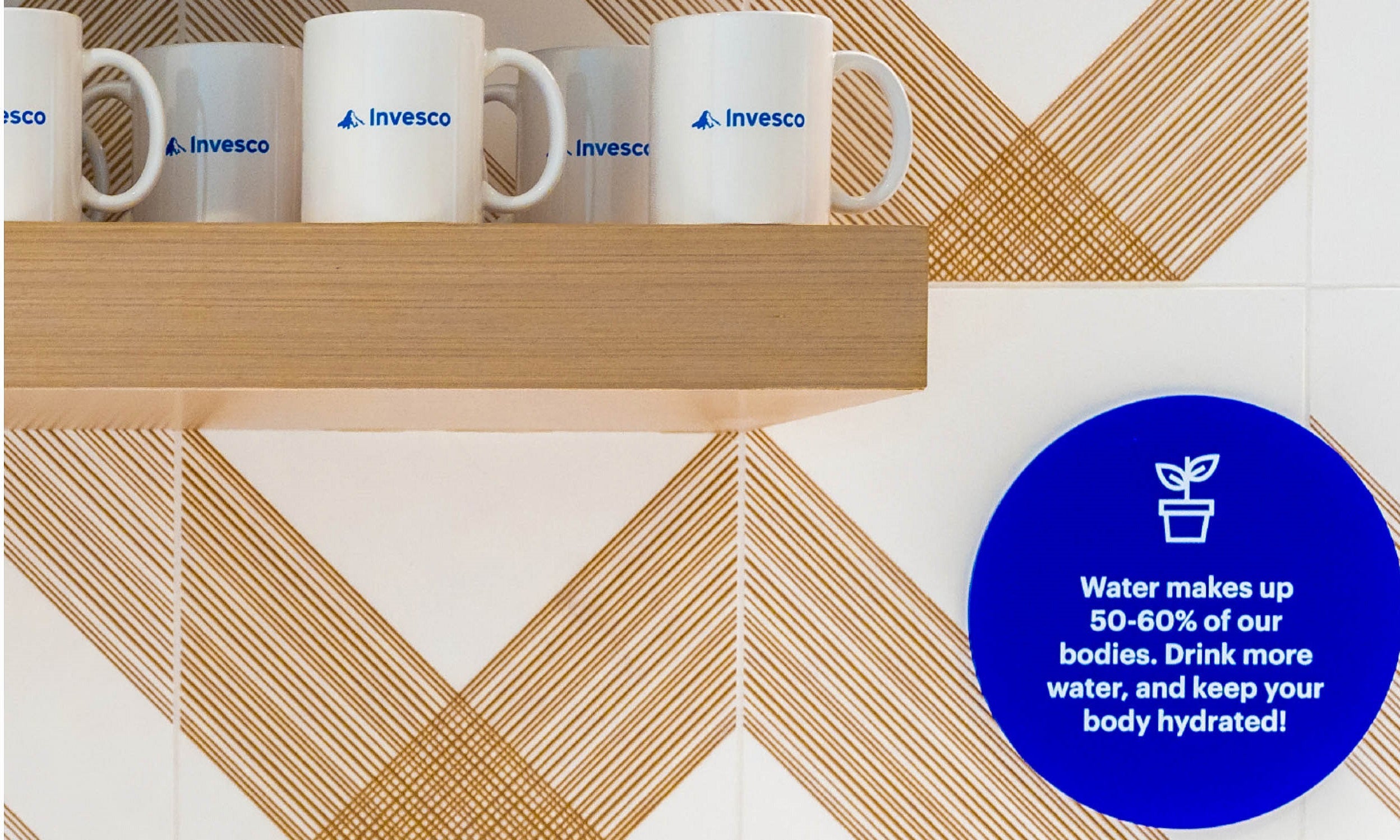  Office kitchen with reusable mugs and educational signage