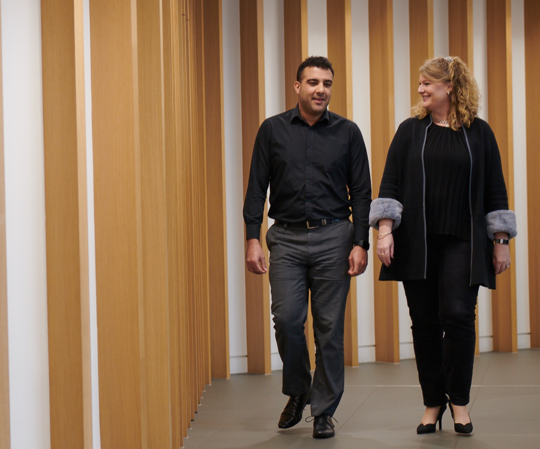 Two people walking in the corridor