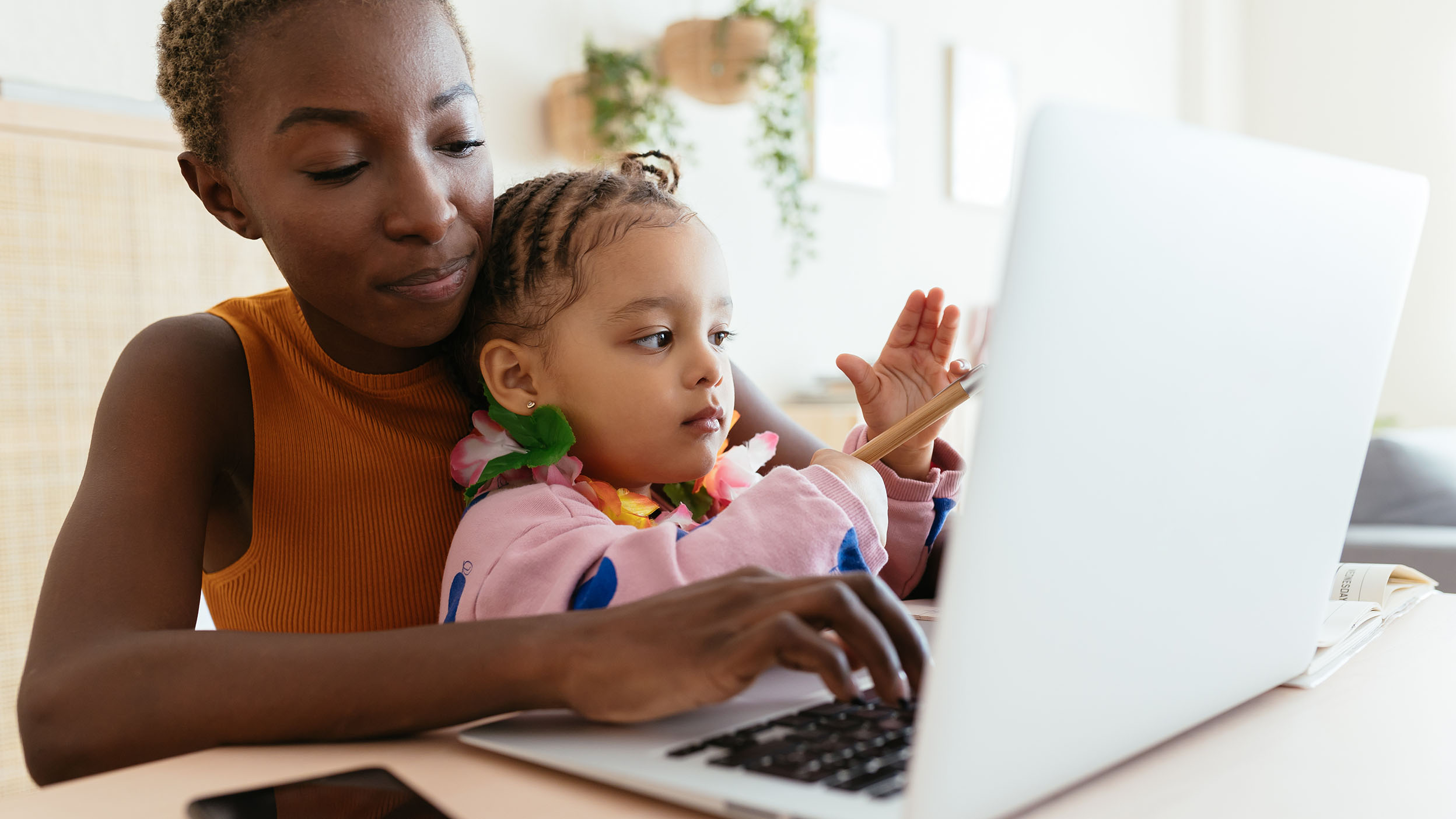Mother and daughter using laptop