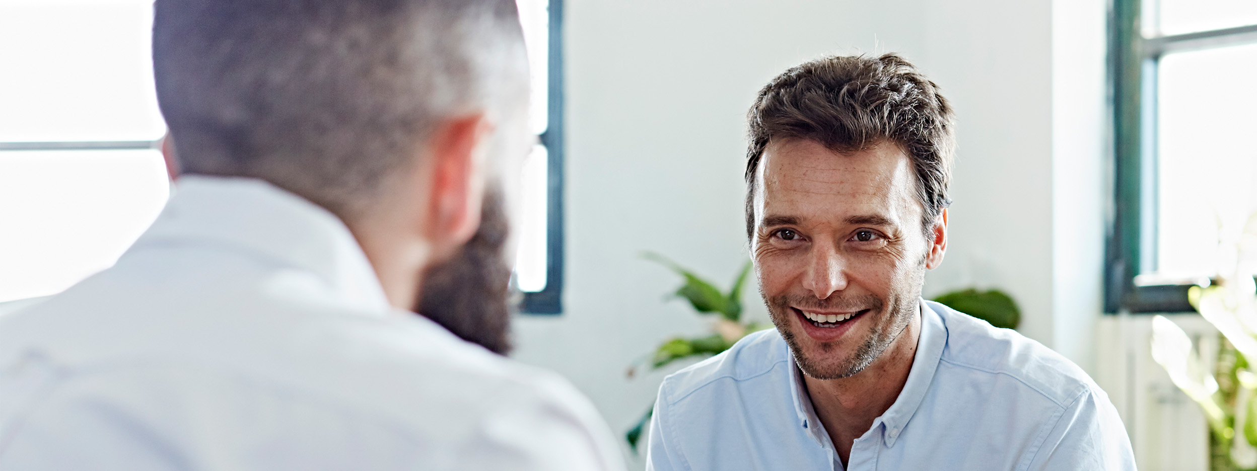 Three professionals in a meeting discussing investment or financial planning