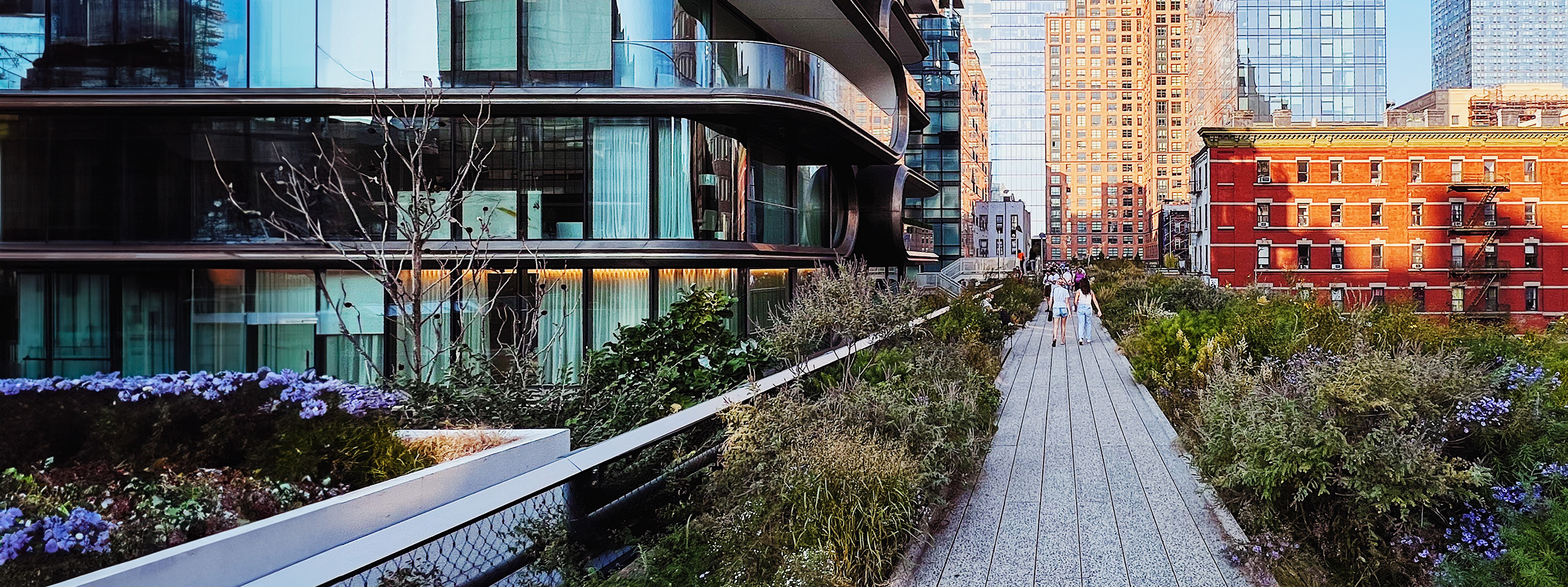 People walking on a pedestrian pathway with buildings on each side
