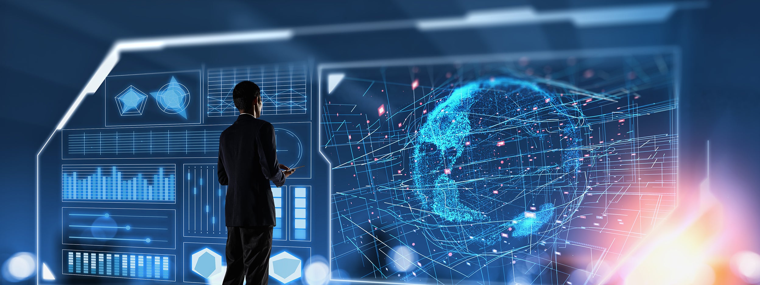 Businessman looking at large screen of data