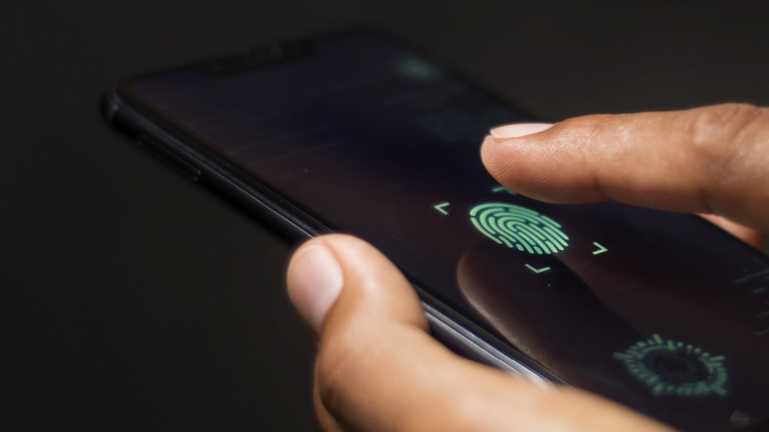 Hand%20holding%20mobile%20phone%20using%20fingerprint%20recognition