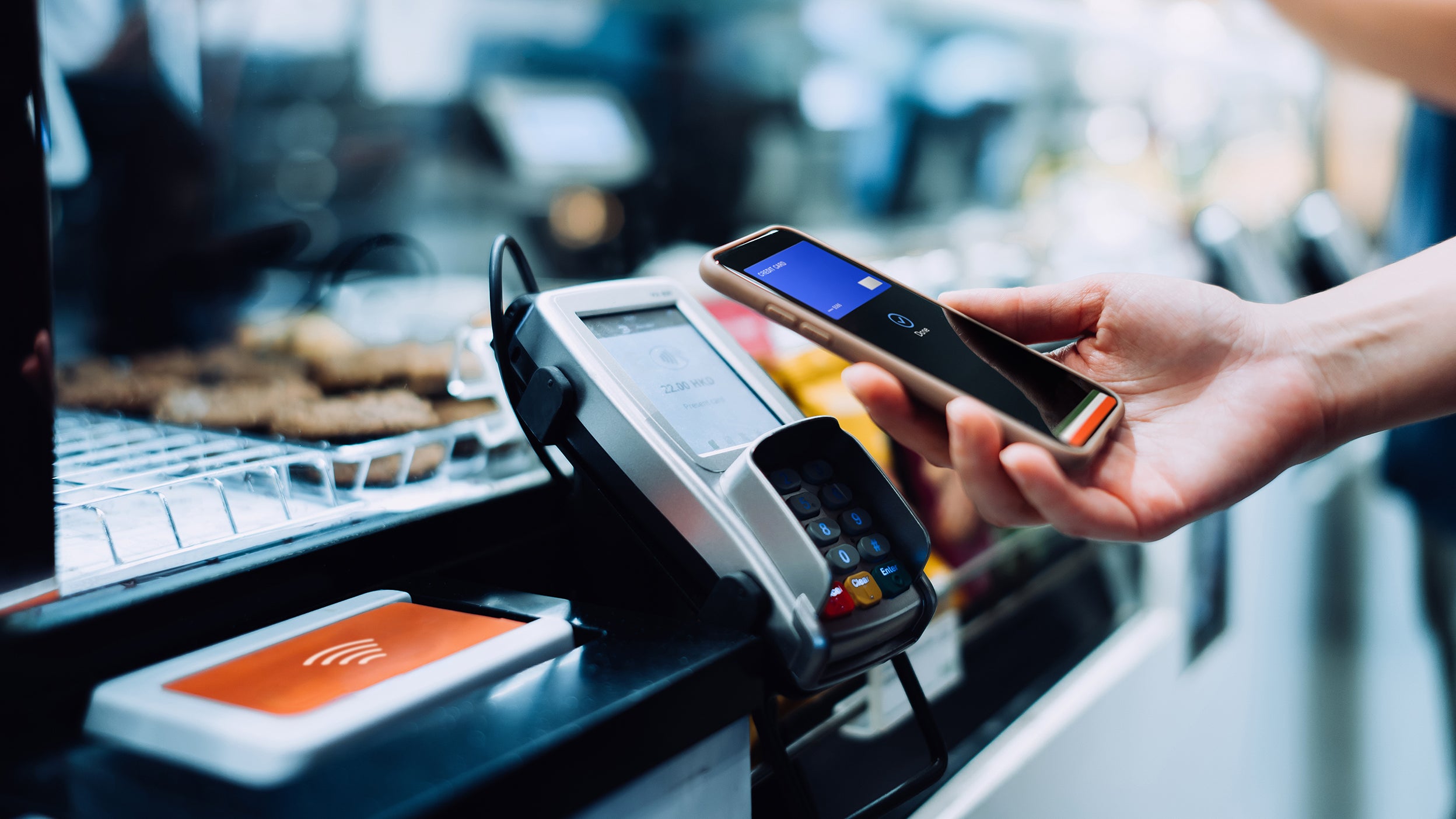 Person using a cellphone to pay for something.