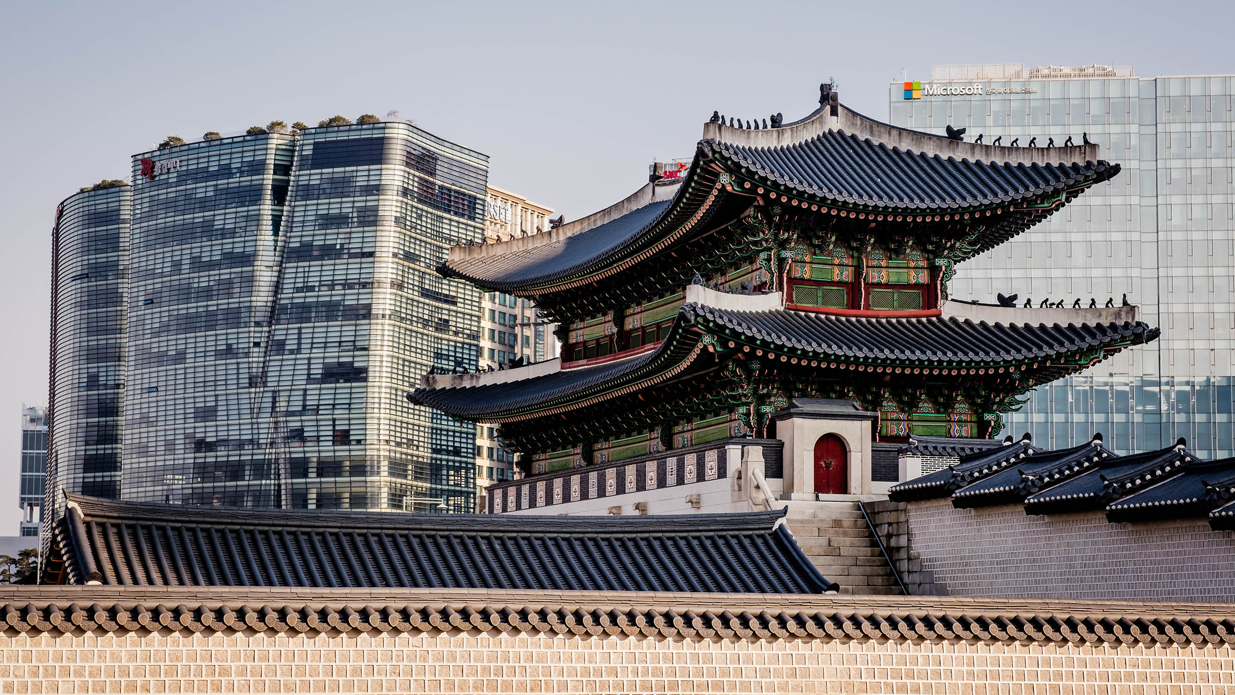 Old Chinese building in front of modern glass facades