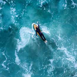 An%20overhead%20drone%20shot%20of%20a%20surfer%20in%20the%20wavy%20sea,%20Newport%20Beach,%20California,%20USA