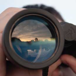 a%20man%20looking%20through%20binoculars