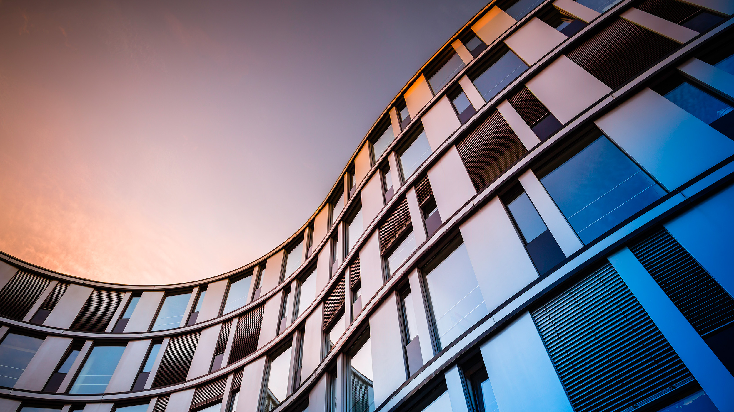 Glass facade of a modern office building in Hamburg, Germany.