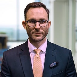 Joe%20Dowling%20speaking%20directly%20to%20the%20camera%20in%20a%20professional%20office%20setting.