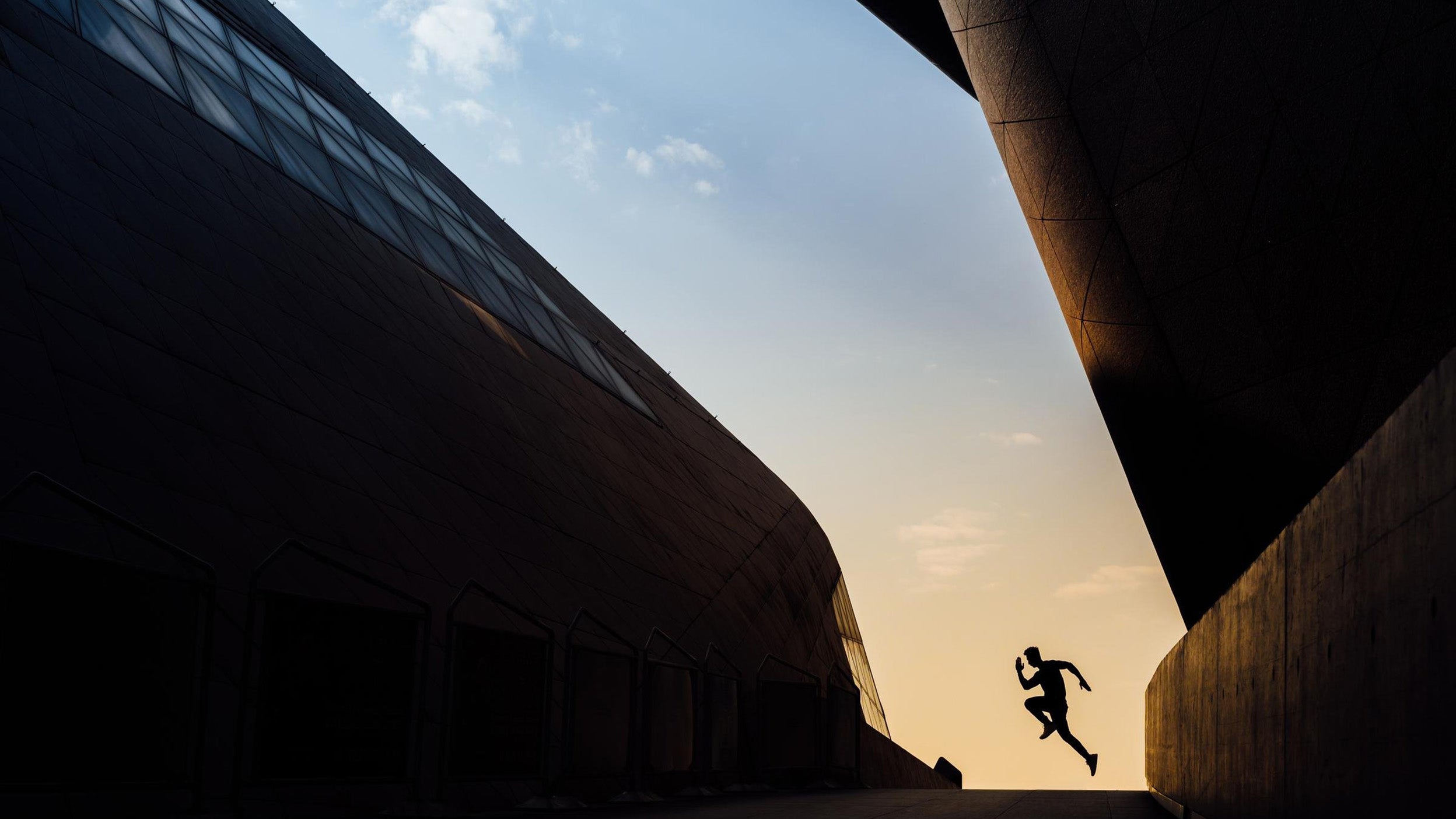 From a distance one young Asian sportive man running in city.