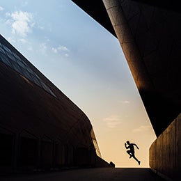 From%20a%20distance%20one%20young%20Asian%20sportive%20man%20running%20in%20city.