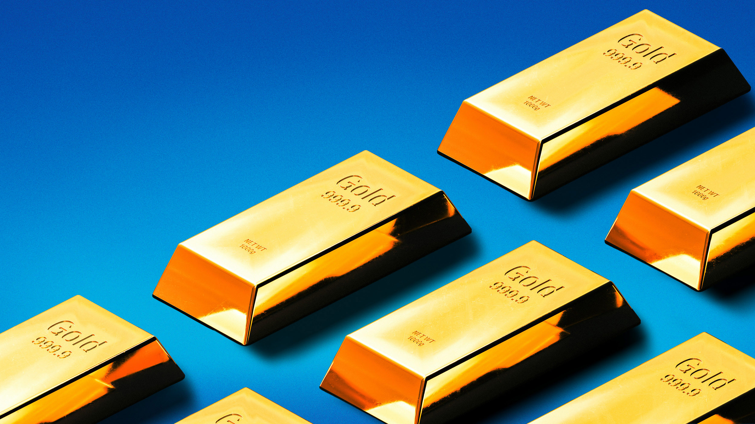 Several gold bullion bars arranged on a bright blue background.