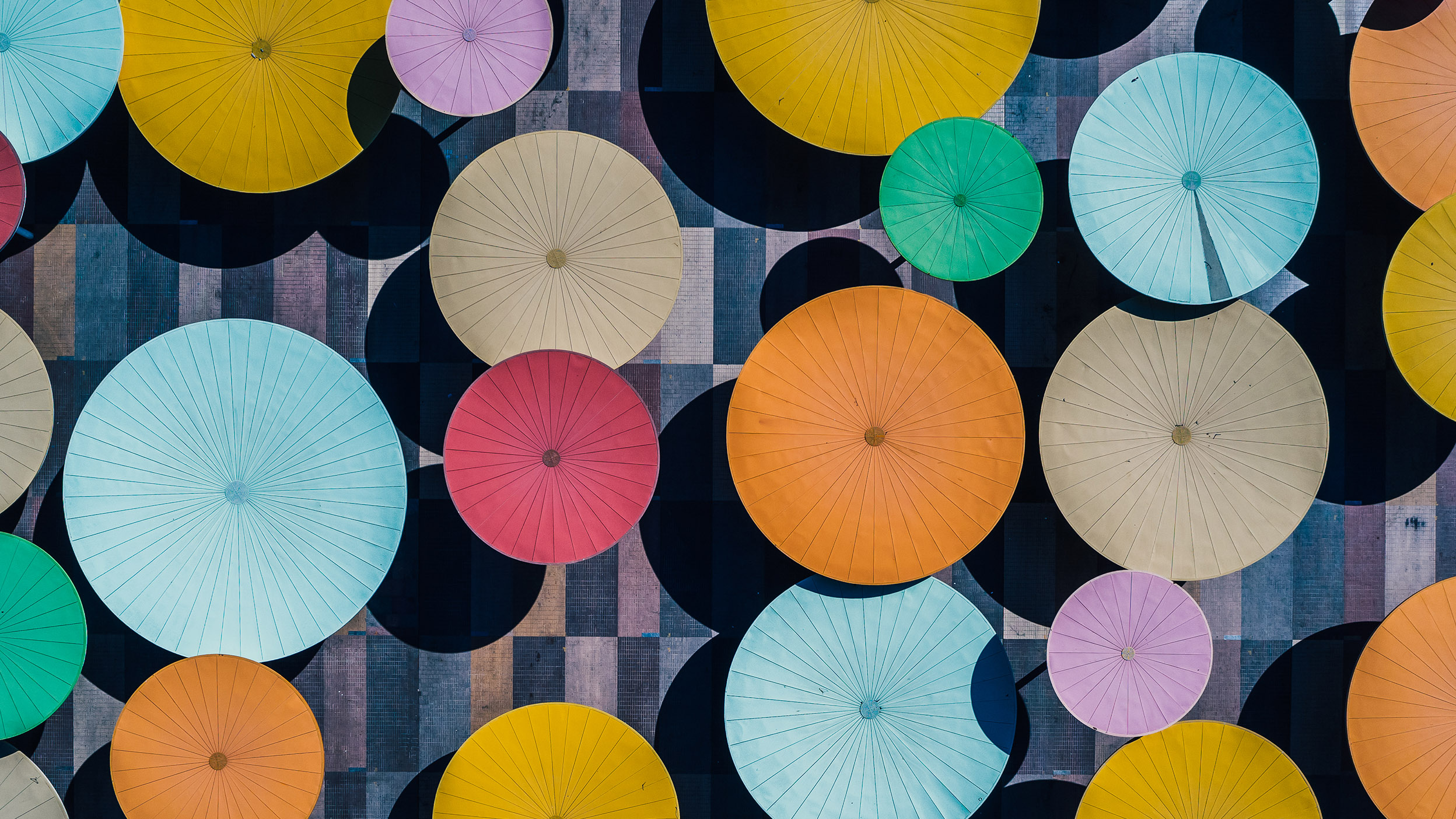 Overhead view of multiple colored umbrellas