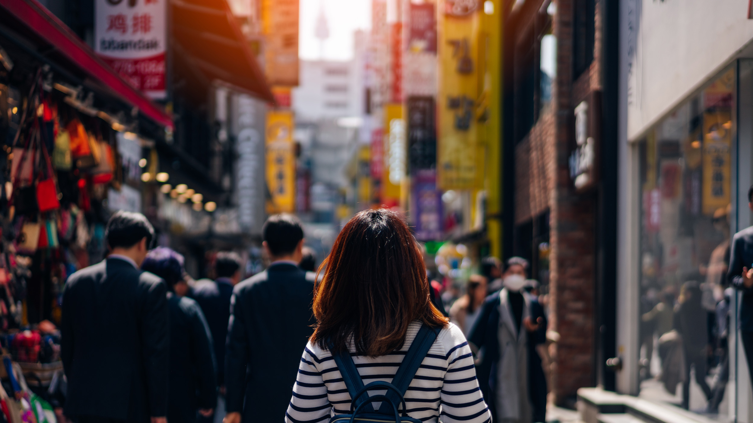 Young asian woman traveler traveling and shopping in Myeongdong street market at Seoul, South Korea. Myeong Dong district is the most popular shopping market at Seoul city.