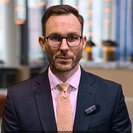 Joe%20Dowling%20speaking%20directly%20to%20the%20camera%20in%20a%20professional%20office%20setting.