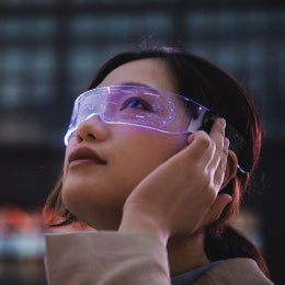 asian%20woman%20using%20a%20smart%20glasses%20in%20front%20of%20an%20office%20building%20(the%20glassed%20used%20in%20the%20shot%20is%20a%20generic%20product%20in%20China)