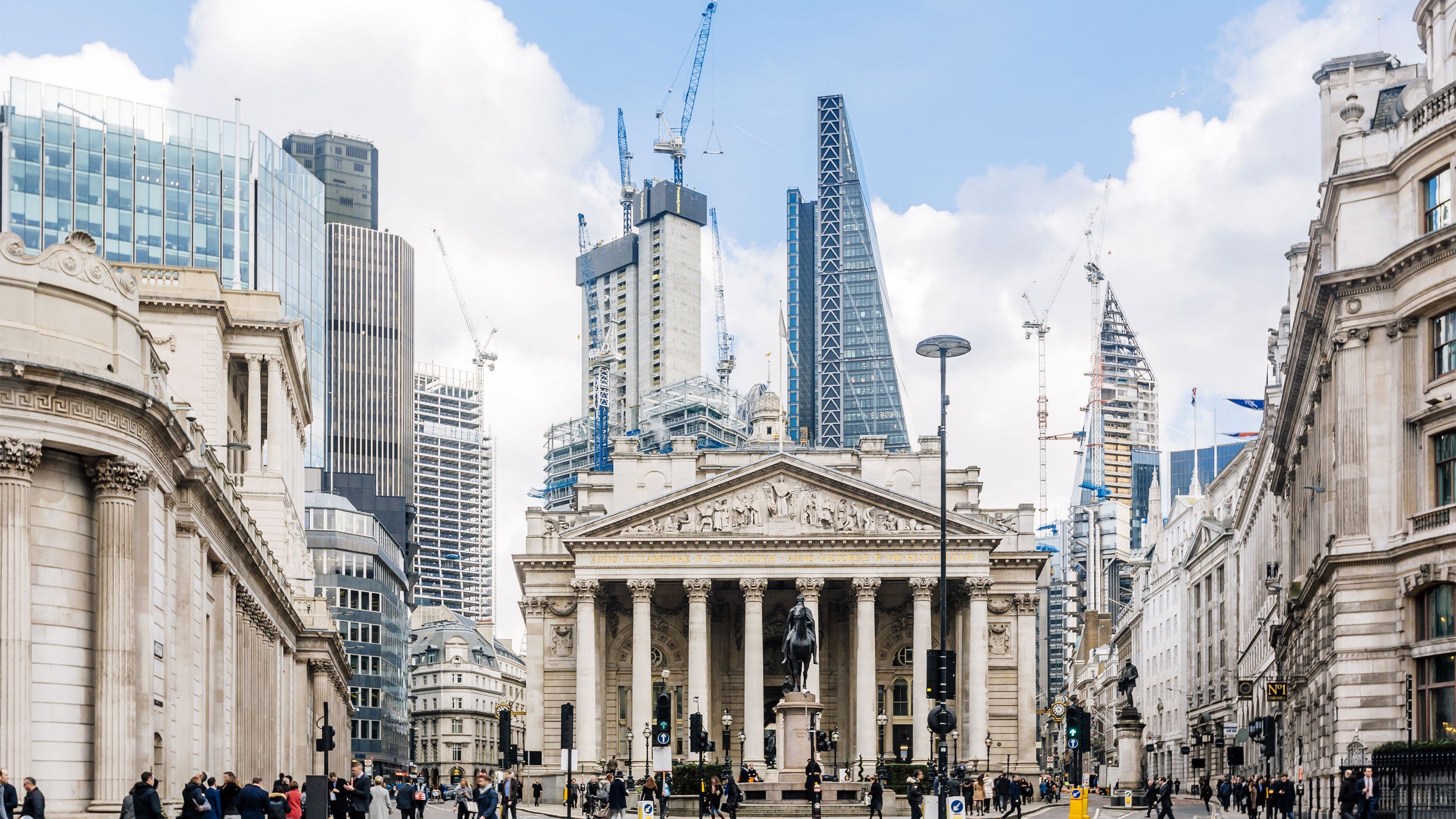 Bank of England area skyline showing historic architecture, modern office towers and construction cranes in the City of London.