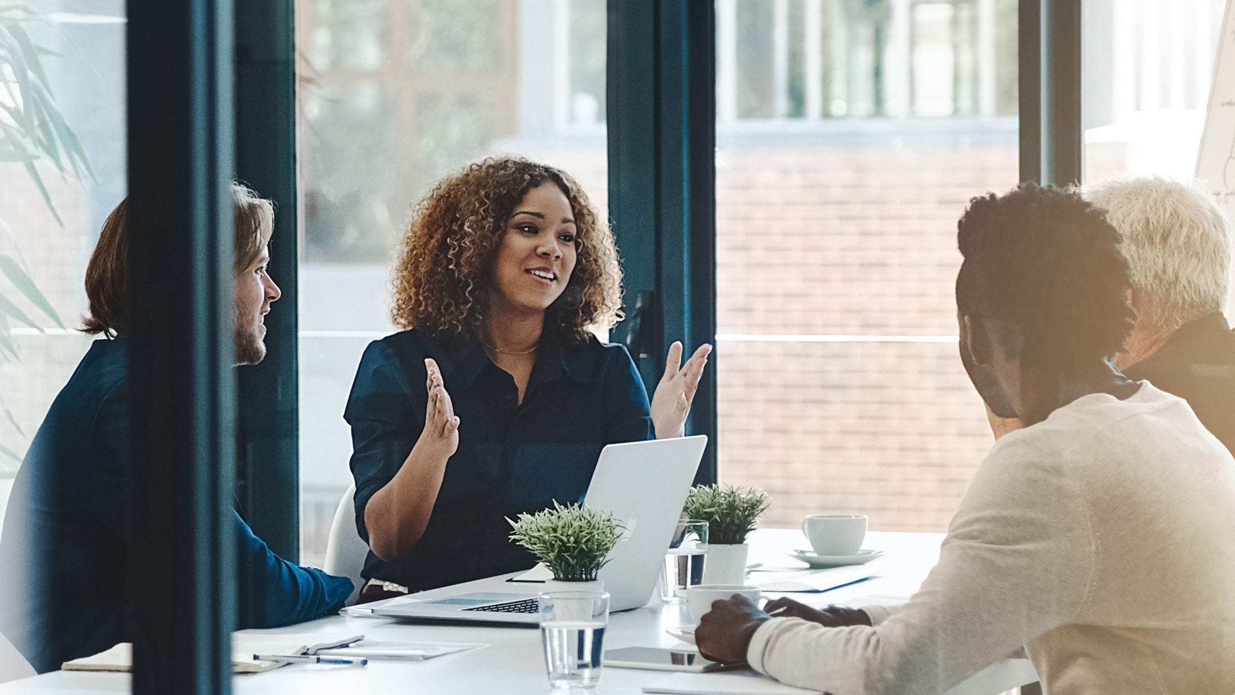 Insurance and investment professionals discussing private credit strategies in a meeting room. 