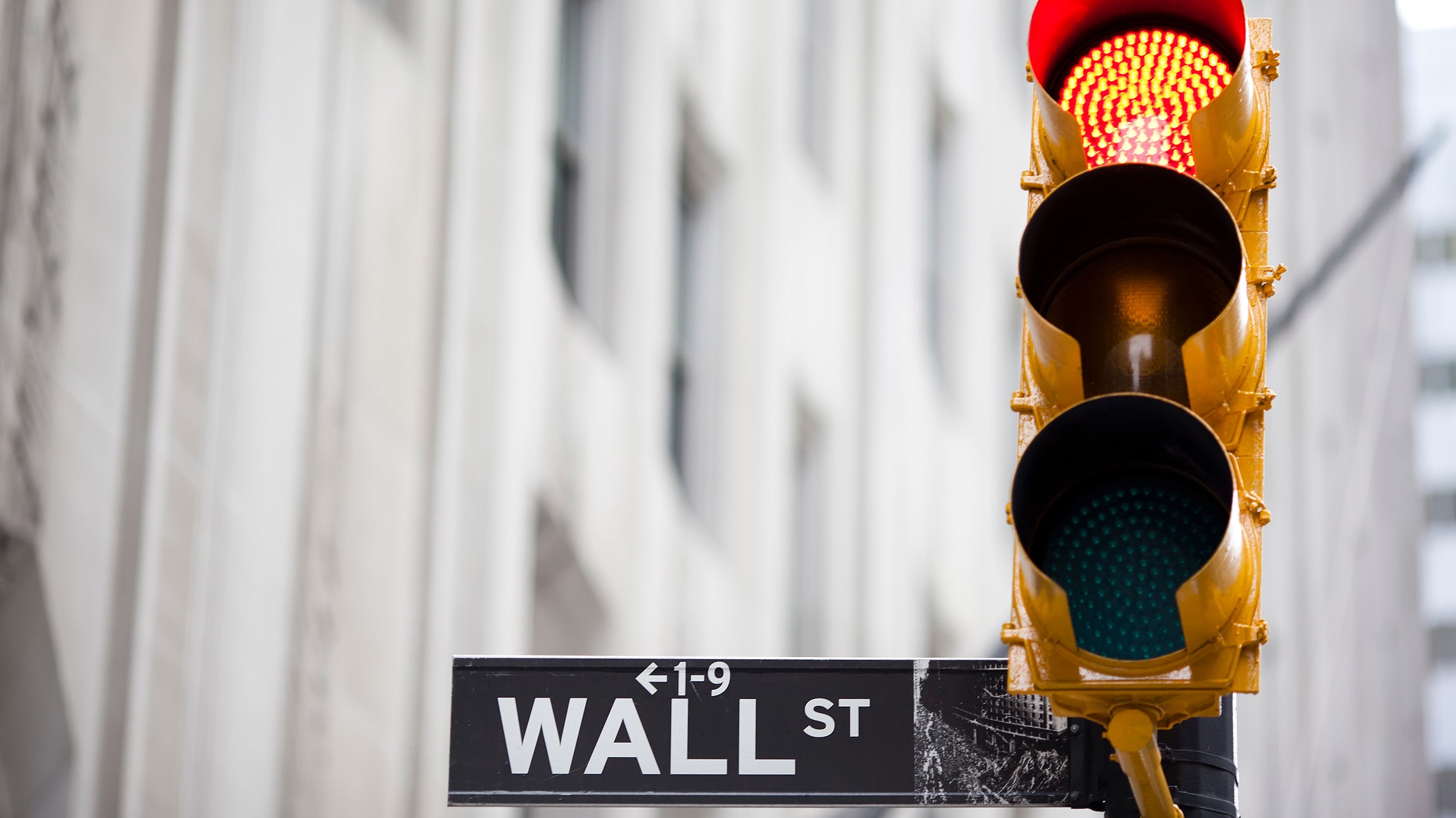 Wall Street sign and red traffic light