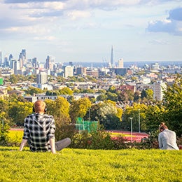 Back%20view%20of%20tourists%20looking%20over%20London%20city%20skyline%20from%20Parliament%20Hill%20in%20Hampstead%20Heath