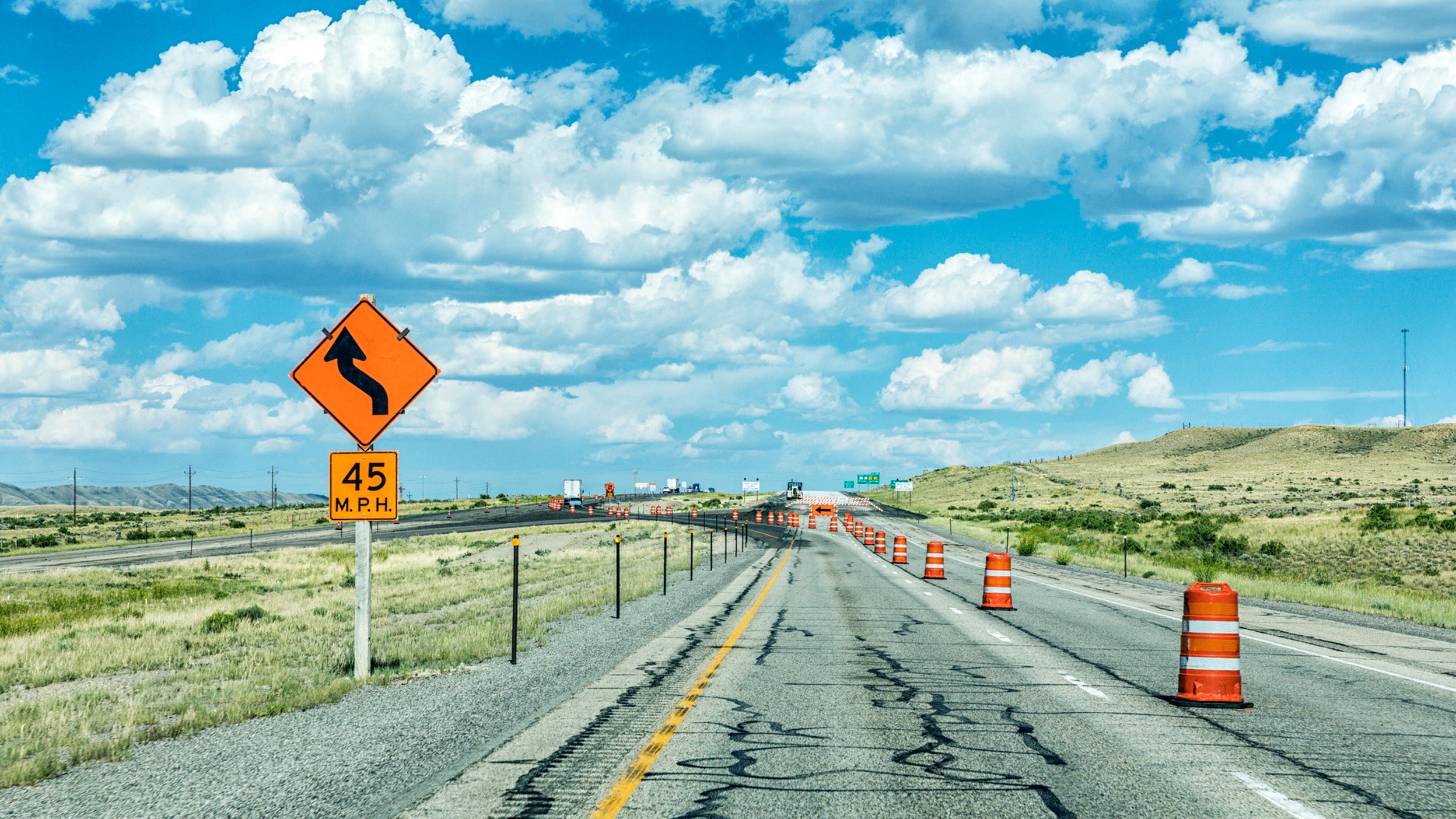 Interstate 80 expressway highway road construction zone detour in the western USA state of Wyoming on a bright summer puffy cumulus cloud day.