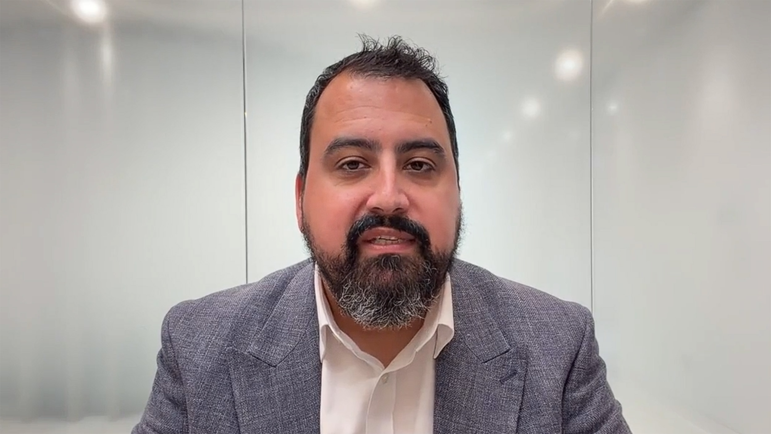 scrrenshot of David Aujla talking in the video