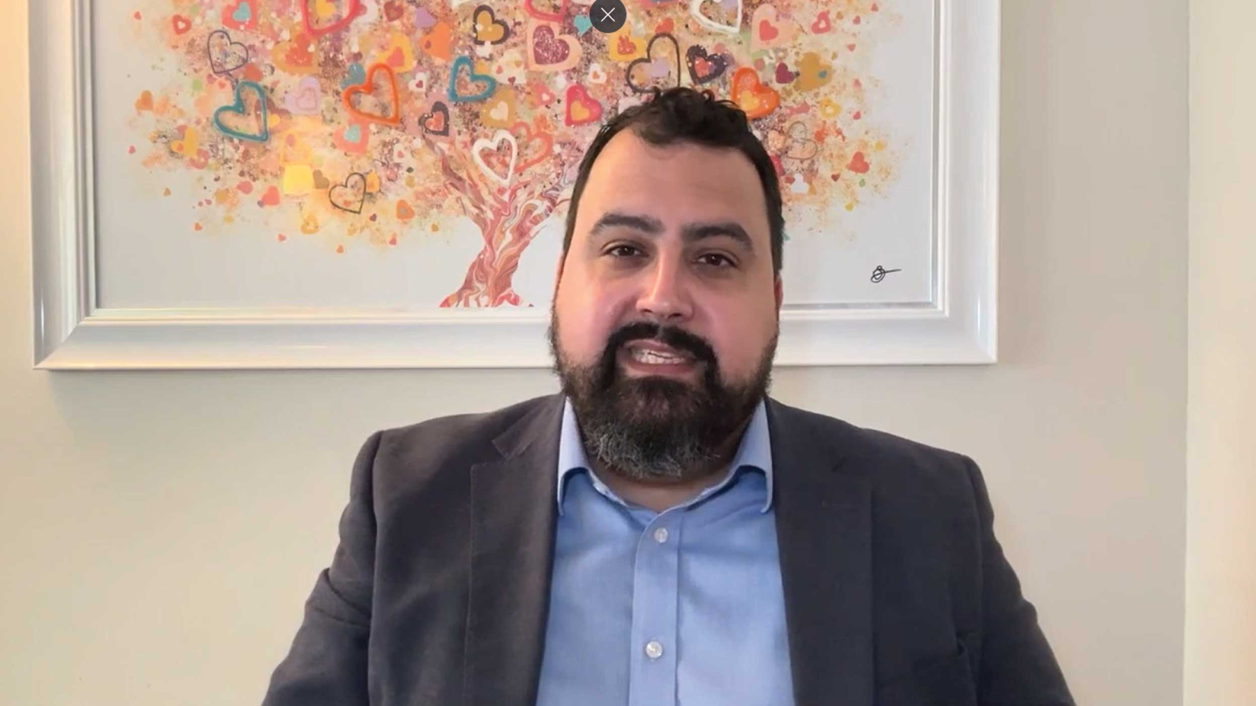 scrrenshot of David Aujla talking in the video