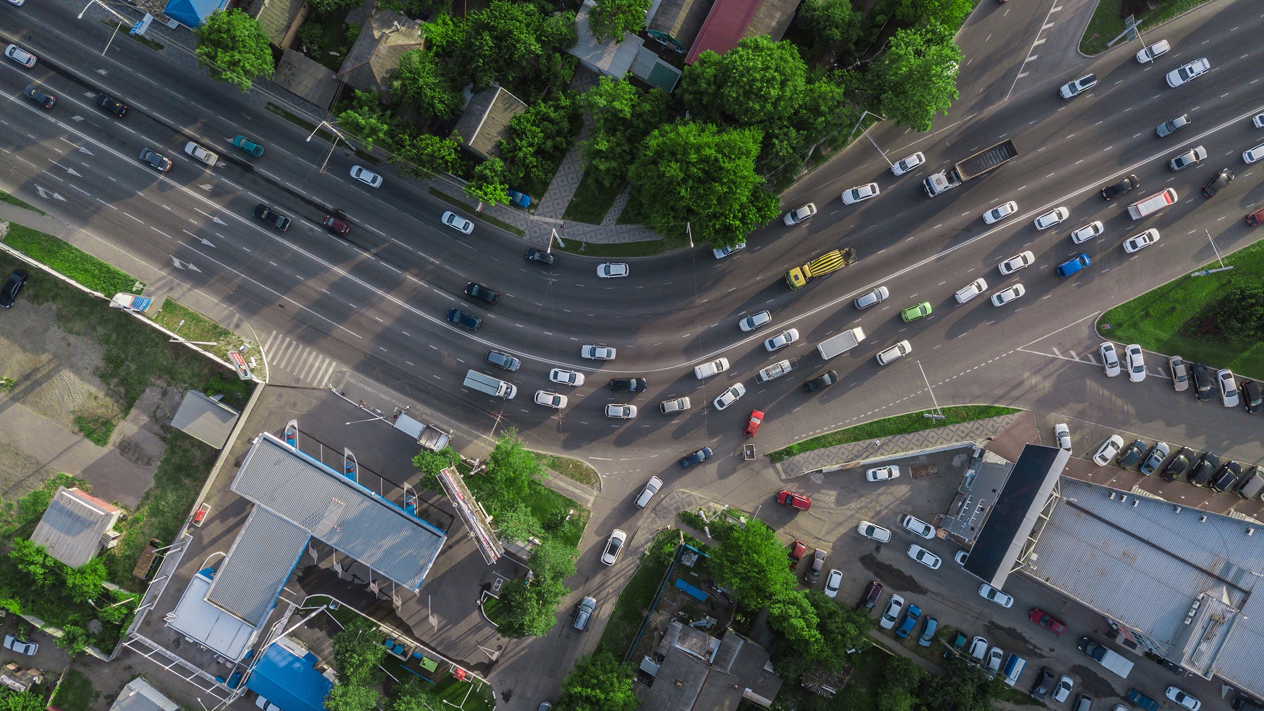 Aerial top view of road junction from above, automobile traffic and jam of many cars.
