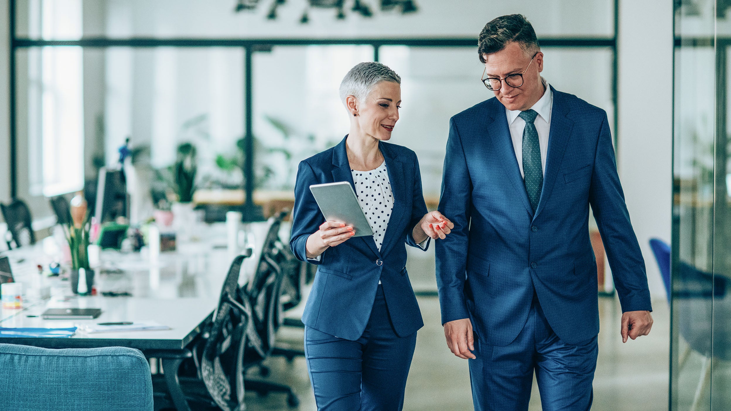 Shot of a businesswoman and businessman talking in the work place