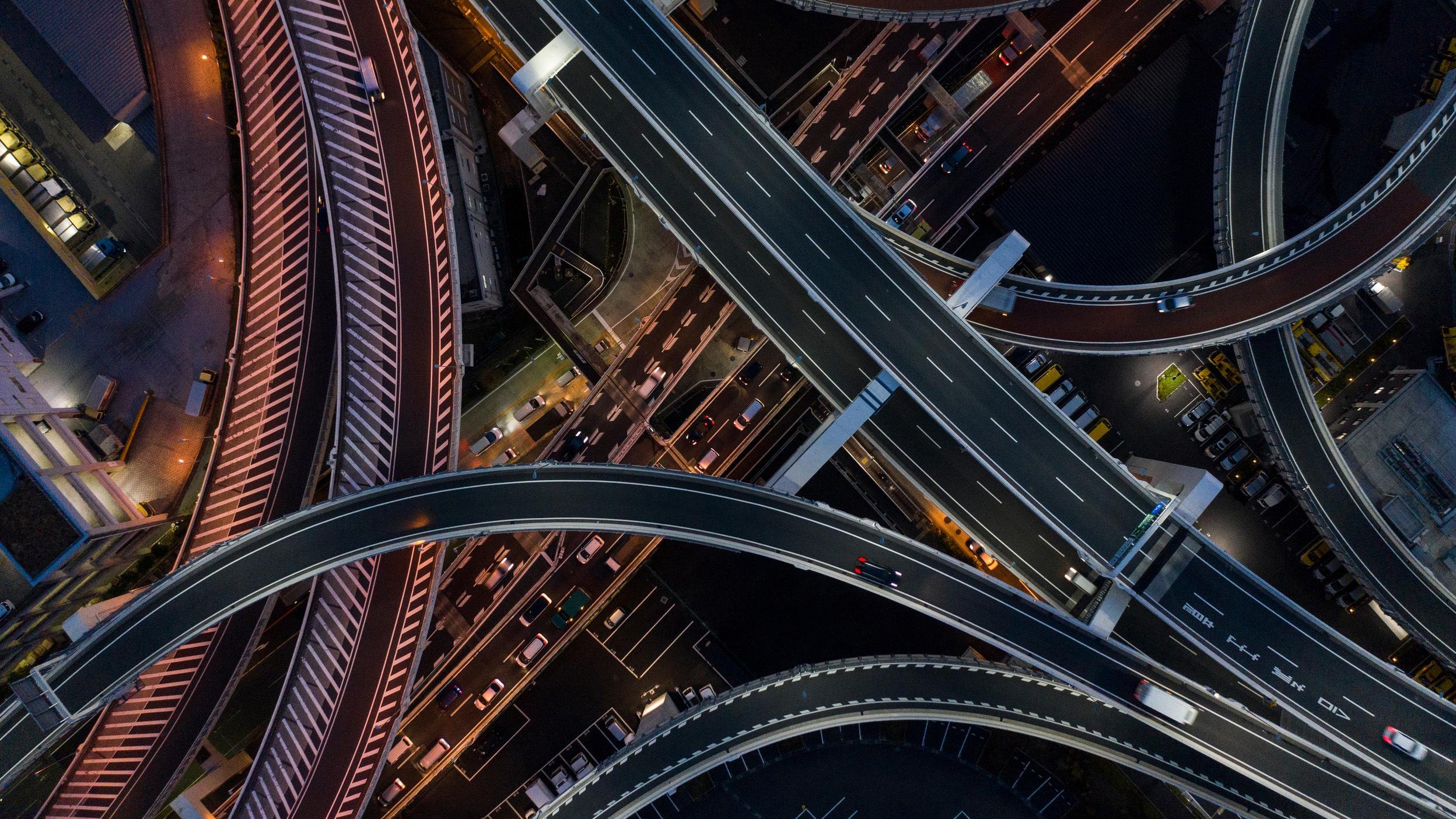 Aerial view of a busy highway interchange at night.