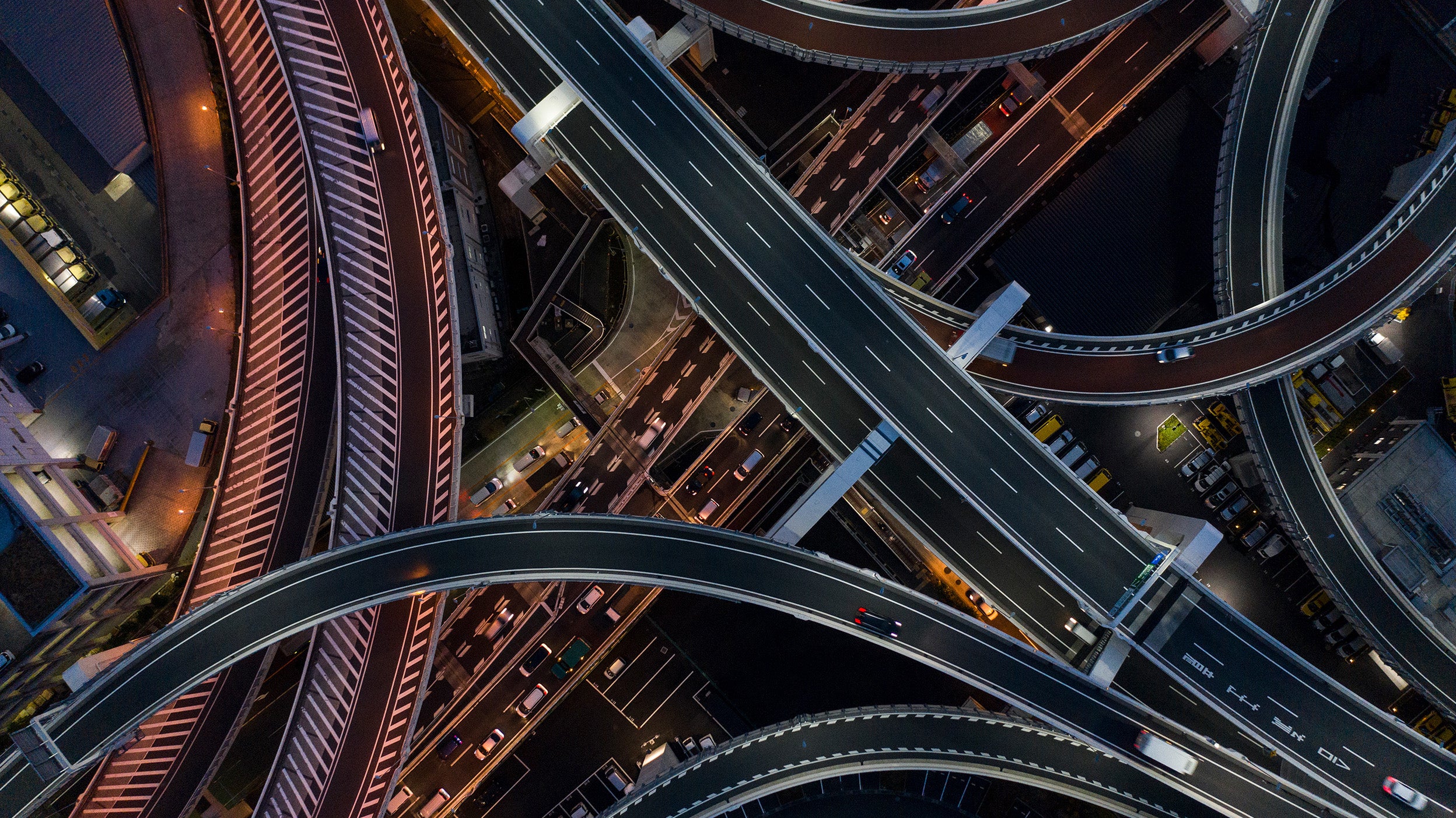 Aerial view of a busy highway interchange at night.