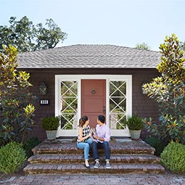 Couple%20on%20the%20front%20steps%20of%20the%20home%20they%20purchased%20together%20celebrating%20drinking%20champagne%20for%20their%20first%20new%20home%20purchase