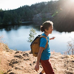 Content%20mature%20woman%20hiking%20near%20lake%20at%20sunrise