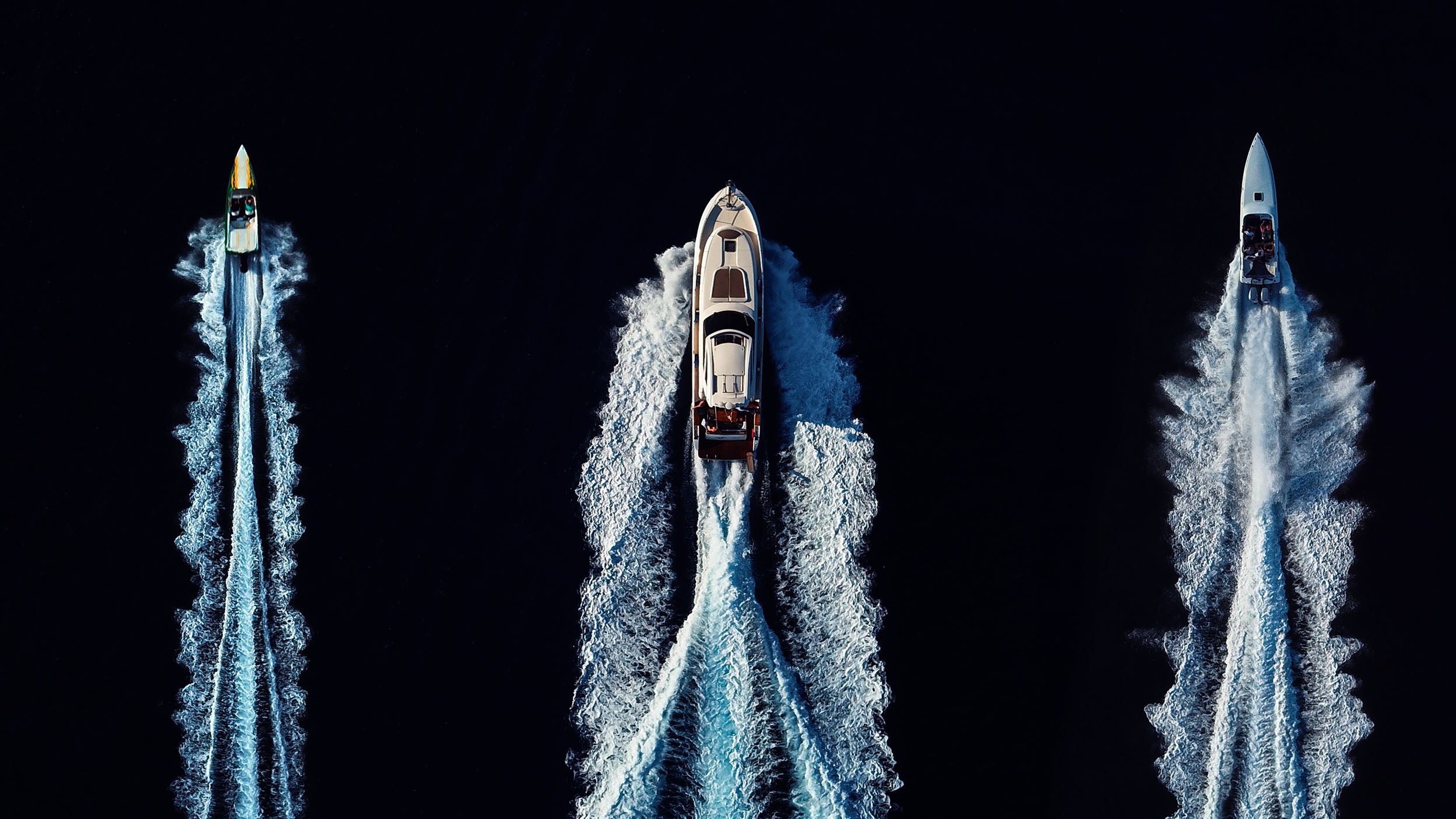 An aerial view of three boats
