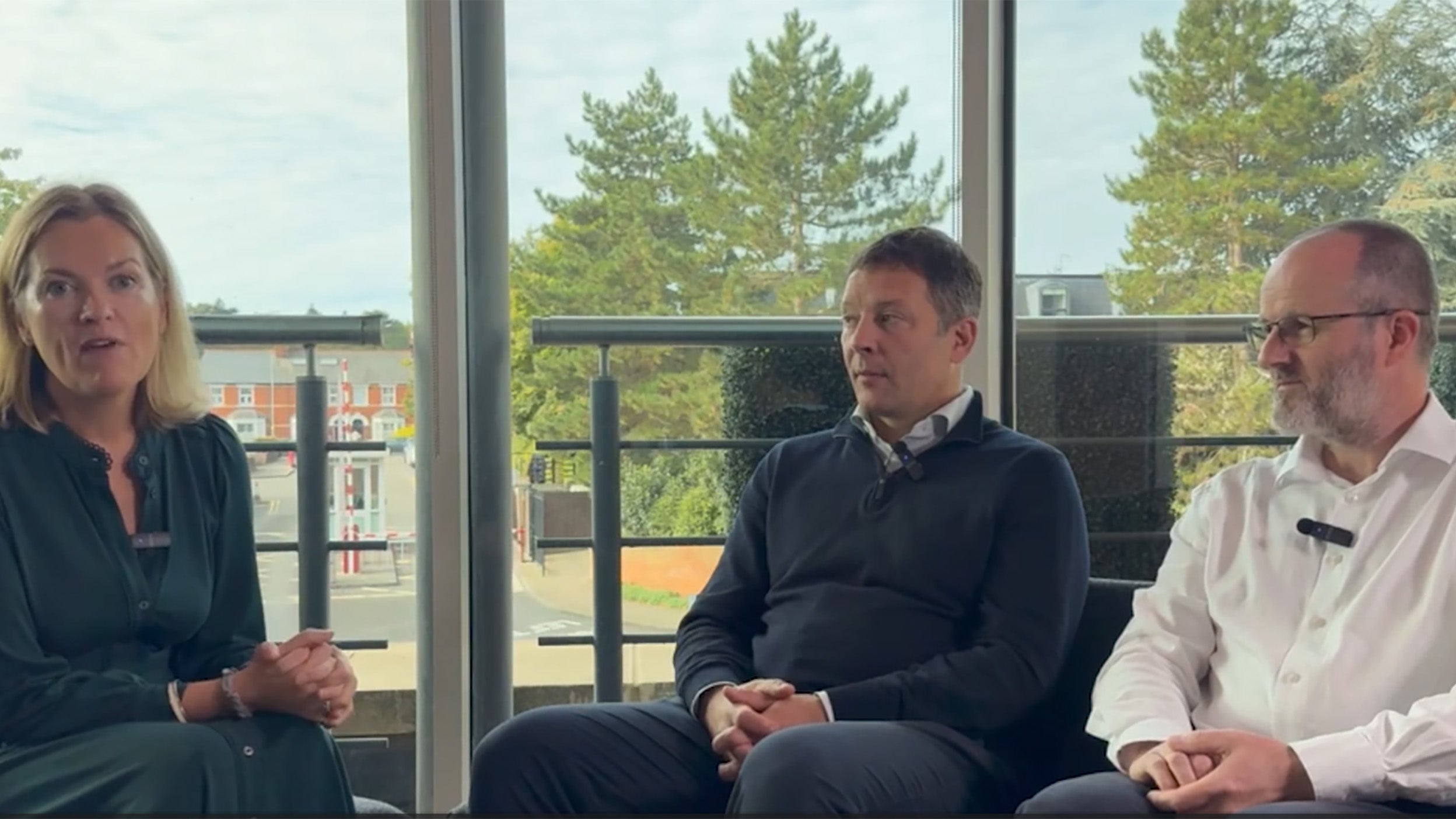UK Equity Fund Managers James Goldstone and Ciaran Mallon sit with Georgina Millar in a meeting room