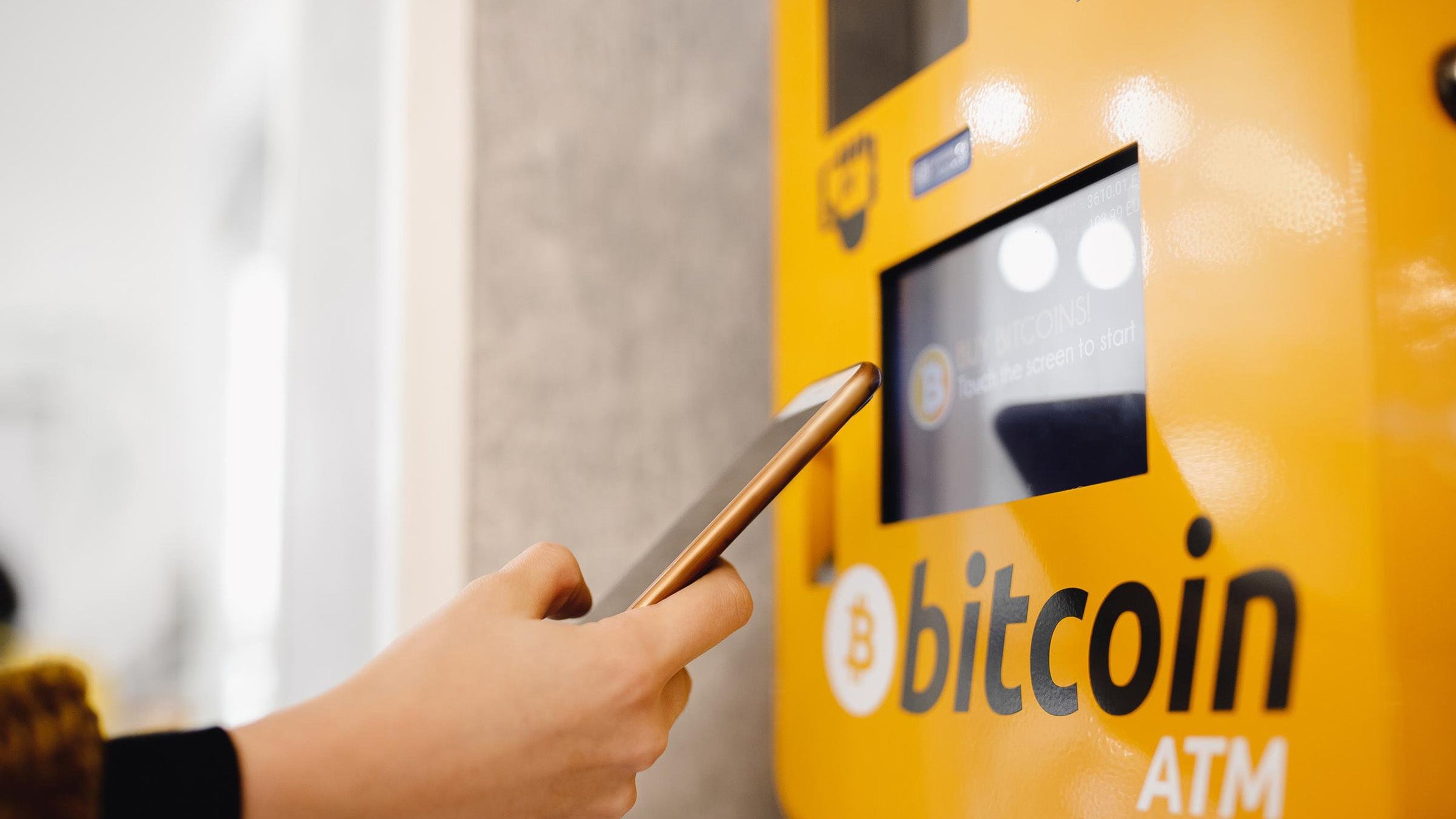 Contactless ATM machine for payment by Bitcoin cryptocurrency. Concept pay mobile phone.