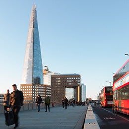 UK,%20London%20Bridge,%20blurred%20motion%20of%20business%20people%20and%20red%20busses%20during%20morning%20rush%20hour